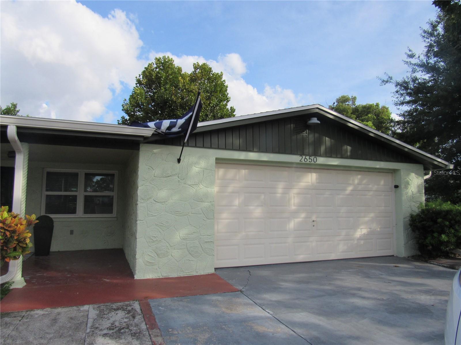 This beautifully updated 3 bedroom, 2 bathroom home is available for long-term lease and offers the perfect blend of comfort, style and convenience. The lakefront location offers serene water views and is located in a quiet neighborhood in Holiday. The interior is beautifully updated with gorgeous ceramic tile throughout, fresh neutral paint, and contemporary finishes throughout. The gourmet open kitchen has stainless steel appliances, quartz countertops, custom cabinetry, and a huge island with countertop seating. The primary bedroom has lovely views of the lake and a walk-in closet and the split floor plan allows for privacy. The heart of the home is a warm and inviting family room with picture windows allowing for a lot of natural light with water views and a wood burning fire place. Just off the kitchen is an interior laundry room, oversized one car garage for extra storage and large circular driveway for multiple vehicles. Out back there is a screened in porch, additional uncovered patio space for a BBQ and a dock with direct lake perfect for relaxing, entertaining, or enjoying nature. All windows are new hurricane rated and roof and AC all replaced within the last couple years. Just minutes from shopping dining, local parks, Gulf Coast beaches and easy access to 19 for commuting. This is a great home don't miss your opportunity!!