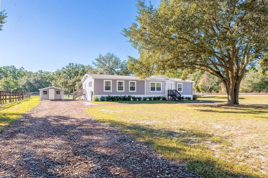 This well-maintained 3-bedroom, 2-bath home sits on a spacious 0.75-acre lot in Morriston, Florida, offering comfortable living in a peaceful rural setting. Inside, the home features upgraded details throughout, including an inviting electric fireplace that adds warmth and charm to the living area. The large open kitchen is a standout, offering upgraded finishes and a center island that provides ample space for cooking, gathering, and entertaining. Outside, the property includes a convenient carport along with a storage and utility building, ideal for tools, equipment, or extra storage. The partially fenced yard offers added privacy and flexibility for pets or outdoor activities while still providing plenty of open space. Located in Morriston, this property is surrounded by Florida’s natural beauty and outdoor recreation. The area is known for its rolling countryside, nearby horse farms, and easy access to world-class equestrian venues such as HITS Post Time Farm. Outdoor enthusiasts will appreciate the proximity to nearby springs, rivers, and trails for kayaking, fishing, and exploring nature, all while being a short drive to Ocala, Dunnellon, and Williston for shopping, dining, and everyday conveniences.