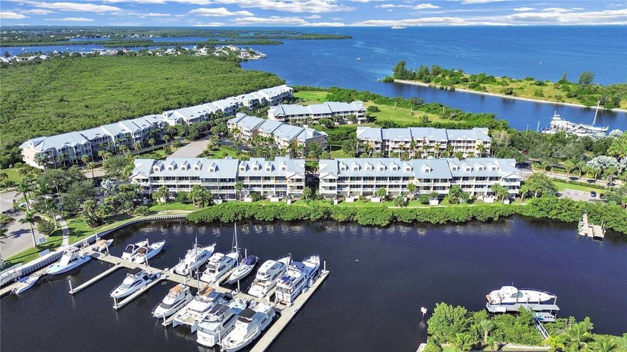 Welcome to the most extraordinary WATERFRONT townhome w/ over $60,000 in tastefully chosen upgrades located in the seaside village of Little Harbor. No expense was spared, no detail overlooked in investments made in making this house a home. As a primary home, it has been meticulously maintained by its sole owner, never hosting a rental. The value of waterfront is in experiencing THE VIEW--both East and West. In this home it begins with 16' of sliding glass doors (essentially, walls of glass) in the lower level living area and upper level primary BR, with each overlooking the Marina and wide salt water canal offering stunning views of this widely sought after boating community. Based on its unique Marina location, each of the 2 East facing 1st and 2nd floor terraces (overlooking the Marina) offer privacy distinct from most other town homes and sunrises equally as breathtaking as the sunsets, creating perfection for terrace dining. Each of the two West facing 1st and 2nd floor terraces enjoy unobstructed private views over open green space and sunset skies.  Endless upgrades were thoughtfully chosen to maximize both storage and living space. This floor plan, originally built with a small linen closet to serve as a kitchen pantry, was upgraded to a custom designed hallway pantry, 4 1/2' x 7 1/2' featuring 16 soft closing, pull out drawers with cabinets above adding an additional 8 shelves. A 7' cabinet was added to the primary bathroom providing 10 storage shelves, augmenting the expansive storage under the vanity. Out of 154 TH’s in this community, only 6 of them (this home being one of those 6) were built to offer a 15'x16' outdoor lanai behind the garage, creating abundant seating, dining and entertaining areas. The jumbo sized screened lanai is perfect for outdoor grilling and dining with your friends overlooking the Marina. All outdoor ground level flooring (including lanai, driveway, garage and storage closet) were upgraded with a seamless polyaspartic flooring creating a luxurious, modern and clean design. All 4 upper level terraces were upgraded with a sophisticated wide plank tile. Both sets of interior stairs feature upgraded modern maple wood steps and landings with modern industrial style aluminum handrails. The primary bathroom shower is upgraded with a modern glass enclosure. Framed mirror upgrades are found in all bathrooms. Lighting has been updated throughout the home. The A/C and hot water heater were both replaced in 2020. In addition to your garage and private parking, just steps away is the convenience of a parking lot for your guests. The community offers an onsite half mile BEACH, 2 waterfront restaurants with sports/Tiki Bar, NEW upscale fishing pier, kayak/canoe boat launch, 2 deep water marinas, high & dry boat storage, Freedom Boat Club, heated swimming pool, tennis and pickleball courts, a fitness center, clubhouse, and playground. Short term AIRBNB rentals allowed. Don't miss the opportunity to own this extraordinary property in an amazing Resort type setting close to Sarasota, St. Petersburg, Tampa with golf courses, hospitals, restaurants, and shopping nearby. Call TODAY to schedule your appointment and start living your dream! Taxes include the CDD.