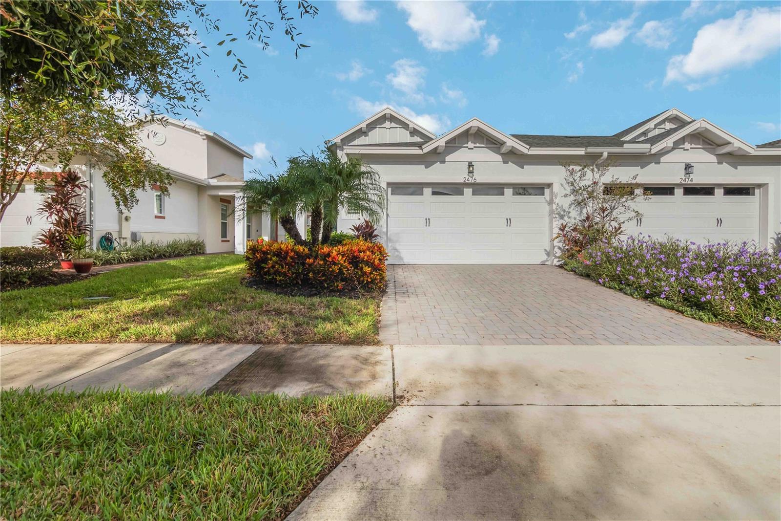 Beautiful Amelia floor plan located in the well sought after Gated 55+ Active Del Webb Twin Lakes community. Twin Lakes HOA is responsible for the exterior of the villa, as well as maintaining the roof of the villa! Walk into the breathtaking property featuring ceramic tile and Engineered hardwood floors in the bedrooms. Professionally painted, Upgraded kitchen 42" Light Cabinets, pantry, custom rounded granite countertops, Custom bubbled glass Pendant lights, and chandelier. The living room features a transit window for extra natural lighting. Sliding glass doors lead to Lanai which features a privacy screen on the lanai that shades the sun, to enjoy your morning coffee or entertaining family and guests. Primary bedroom features a tray ceiling, and ceiling fan with light. The primary bedroom bathroom features a walk-in closet with shelving, glass shower doors, custom shaped flooring in the shower, and custom tiling. Double vanity granite countertops. Laundry room has tailored lower cabinets for great storage. Guest bedroom ceiling fan with light and custom blinds. Amenities include a Resort style pool, Lap Pool and 3rd pool on the carriage house side, 20,000 square foot Gorgeous Clubhouse, State of the art Fitness Center, Flex room, Tennis Courts, Putting Green, Walking Trails, Pickle Ball Court, Fishing, Kayaks, Pontoon Boats and Jon boat to use on Live Oak Lake! The community has many active and socializing activities. View today!