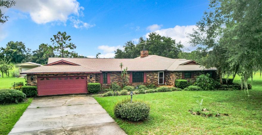 Welcome to this extraordinary opportunity to own 5+ acres of Privacy and Tranquility in this astounding family home. Take advantage of country living meanwhile remaining close to all the local amenities.  This beautiful estate is less than a mile from the Villages, restaurants and shopping. Plenty of room to add a pool, a mother-in-law suite or other out buildings. The possibilities are endless. The spacious 5394 sq. ft. home offers a beautiful foyer area, large 3 bedrooms and 3 full baths with the possibility of a forth bedroom with closet. The large master suite offers a walk in tub and a walk in closet with maintenance free hardwood flooring in the bedroom and tile in bathroom. The interior layout includes a sunken formal living room, formal dining room, Family room with mosaic tile art in the middle of floor and features a stone wood burning fire place. There is also an eat in kitchen with salon doors leading into formal dining room and bay windows with seating. Also included is a Florida room under air with plenty of windows, an inside storage room, a library/office room and a laundry area near the 2 car garage. The hot water heater is less than 1 year old. Exteriorly, there is a whole house generator, a detached two car garage or it could be a storage area or a man cave. The possibilities are endless. There is also a small screened house that could be a green house. There are two porches out back. One is screened and the other is not. Plenty of room for family gatherings and Bar-b-Ques or sit and enjoy the manicured yard.