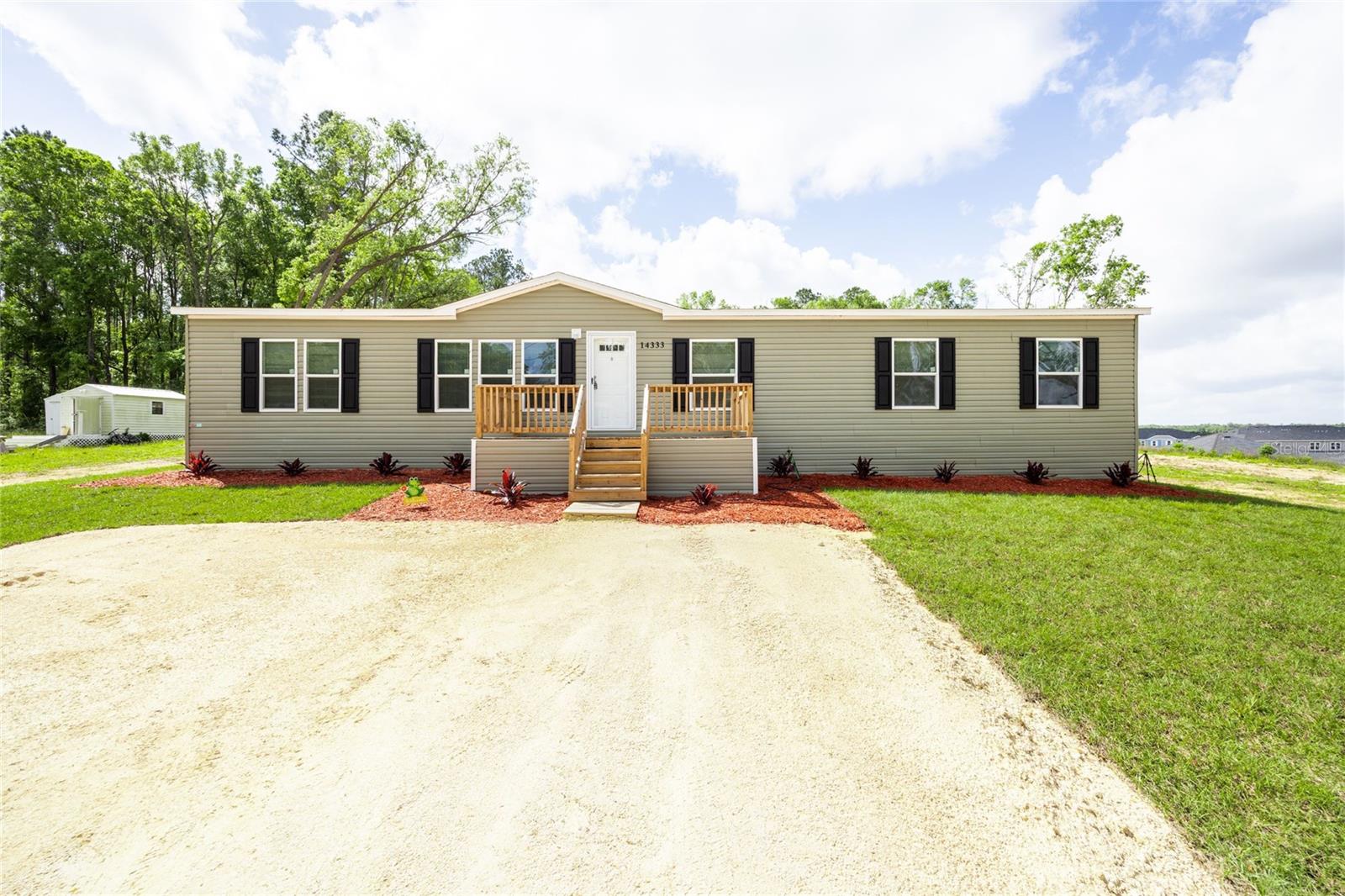 PRICE SLASHED ANOTHER$10,000.00!!! SELLERS ARE MOTIVATED!!! MUST SELL NOW!!! BRAND NEW! Great modern design floor plan with this beautiful 2024 Manufactured home on a 0.82 acre lot within the City of Alachua (that's almost an acre!). Conveniently located to Downtown Alachua, Gainesville from three directions and I-75. Four Bedroom two bathroom upgraded 1,768 square foot home with a great open floor plan. 4 spacious bedrooms and 2 full baths, open concept kitchen with new contemporary appliances and plenty of upper and lower cabinets and a large island. Lots of energy efficient windows throughout the home give plenty of light and fresh air. Wood inspired luxury vinyl flooring throughout the home. Primary suite includes large bedroom, large walk in closet and en-suite bathroom with soaking tub, walk in shower and double vanities. This home is nicely situated on a 0.82 acre lot with plenty of room to garden, play sports, to have guests over for a picnic and to have storage buildings for toys and things. This home is affectionately named "Bubba" by the Sellers. There's plenty of room for parking for residents and guests. This home provides nicely for life with small town charm. ***Please note that the property taxes of $453.11 do NOT reflect the home being on the property. ALSO NOTE, THAT AN EXACT DUPLICATE OF THIS MANUFACTURED HOME IS AVAILABLE BEHIND THIS HOME AS MLS # GC529931 AND IS KNOWN AS "BETTY." One may be more suited to you than the other, or you may want to buy BOTH!