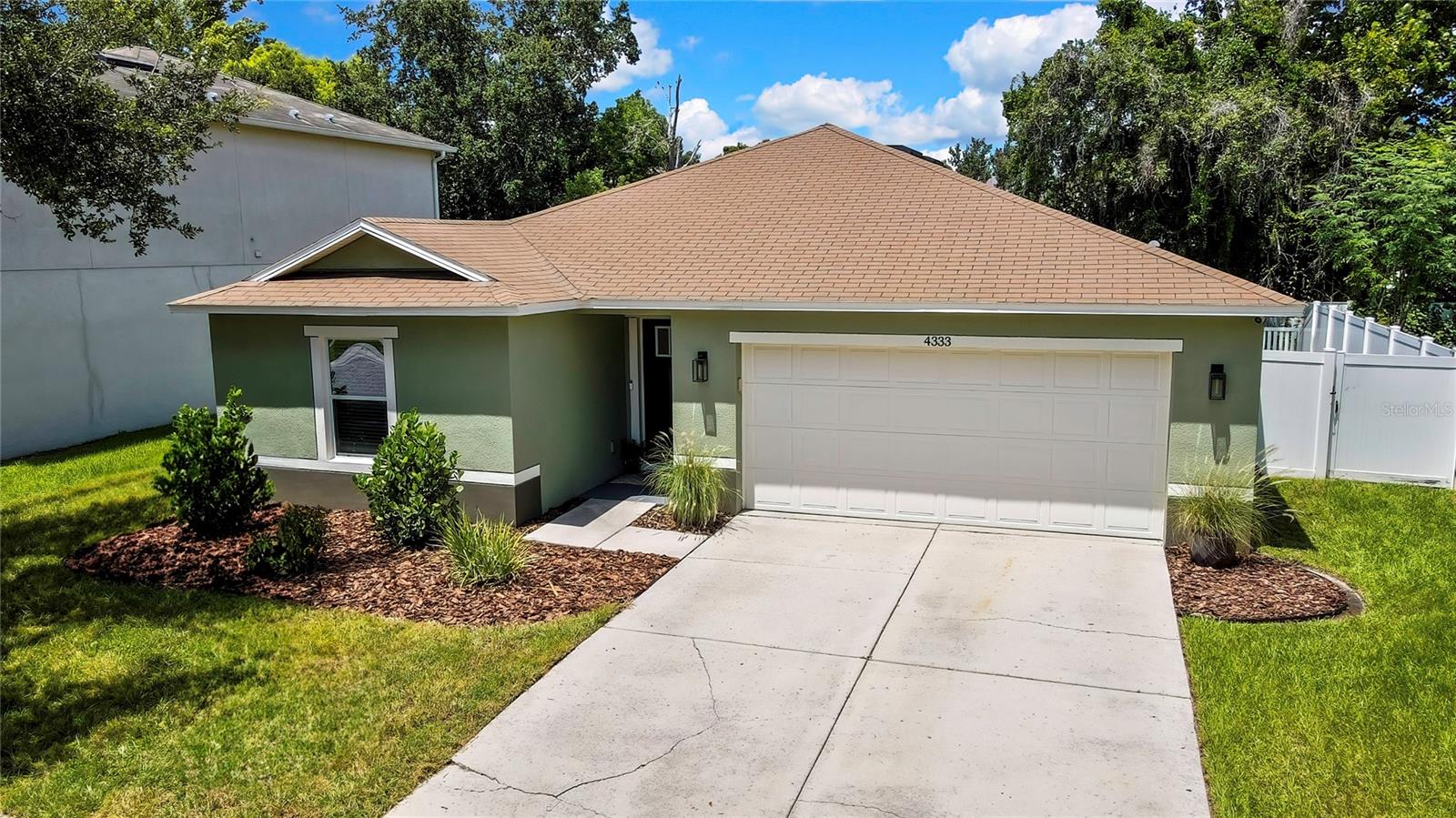 Step into comfort and charm on this beautifully landscaped lot, featuring fresh sod, vibrant new plantings, and new exterior paint that enhances the home’s curb appeal. This thoughtfully maintained 3-bedroom, 2-bath, 2-car garage home is located in the highly desirable Brookfield Estates community in Wesley Chapel. Built in 2012, the 1,439-square-foot residence combines stylish modern finishes with smart, functional design. Inside, crown molding adds a touch of elegance throughout the home. Just off the foyer, the first bedroom features stylish laminate flooring and convenient access to a full bath complete with a granite-topped vanity, crown molding, and a tub/shower combo. The second bedroom also offers attractive laminate floors and ample natural light. The home’s open floor plan flows seamlessly from the foyer into the spacious living and dining areas and into the kitchen, creating an ideal layout for both everyday living and entertaining. The living room is wired with built-in speakers, perfect for entertaining or movie nights. The kitchen is a showstopper with granite countertops, a stunning herringbone tile backsplash and decorative tiled accent walls, a central island, and a full suite of appliances including refrigerator, range, microwave, and dishwasher. A closet pantry offers additional storage. The private primary suite features laminate flooring, a peaceful view of the backyard, and a large walk-in closet with custom built-ins. The ensuite bath includes a double vanity with granite counters, a tub/shower combo, and a linen closet with ample storage. Sliding glass doors from the living room open to a covered lanai and a paver patio surrounded by a river rock border. Enjoy privacy in the vinyl-fenced backyard, complete with a gate that leads to a conservation easement area. The laundry room is equipped with a butcher block counter above the washer and dryer hookups plus cabinets and a closet for convenience. Located in a quiet neighborhood with NO CDD fees and LOW HOA, Brookfield Estates also offers a community park and playground. You're just minutes from top Wesley Chapel attractions including The Shops at Wiregrass, Tampa Premium Outlets, The Grove, KRATE, Epperson Lagoon, ice rinks, cinemas, medical facilities, and renowned dining options. For outdoor enthusiasts, Wesley Chapel District Park is just a short drive away, offering 143 acres of recreation including athletic fields, a playground, tennis and basketball courts, picnic areas, a fitness trail, and a scenic fishing pond. With immediate access to Highway 54, and quick connections to I-75 and I-275, commuting to downtown Tampa, MacDill AFB, St. Pete, or even Orlando’s theme parks (just 1.5 hours away) is a breeze. This home has it all—style, location, and comfort. Schedule your showing today and imagine the memories waiting to be made in your new home.