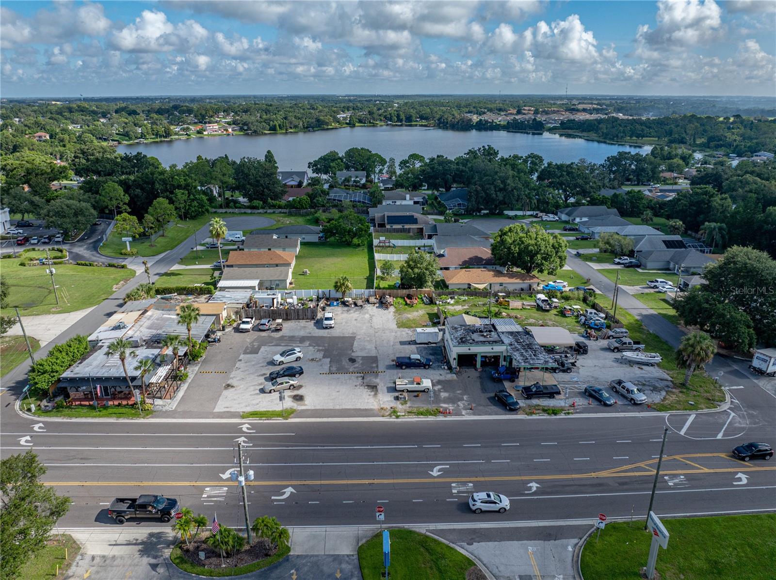 PRIME COMMERCIAL PROPERTY! Fantastic location with High Visibility, 300 ft. frontage on Cypress Gardens Rd. SE situated between Jefferson Rd and Tyler Rd. The collaborative property consists of 3 parcels that include a block building that houses a well established lounge/bar, a 2 BD/ 2 BA frame residential building, a large parking lot, and a garage with two bays. The service station also once was a small restaurant and had new plumbing and electric installed to meet the requirements of operating a restaurant on the premises. The lounge/bar building boasts a tropical theme décor complimenting the covered deck & seating areas; the bar has a game room and plenty of storage space inside and outside. The paved parking lot provides over 30 spaces and stands between the lounge and the garage that is equipped with 2 bays, an office, carports & covered storage. There is also a 4COP LIQUOR LICENSE available but is sold separately from the real estate. Winter Haven is the second most populous city in Polk County. This location is highly traveled, nearby is LEGOLAND and the surrounding community includes shopping centers, restaurants, hotel, department store, supermarkets, residential, banking and more. Call today to schedule a tour of this prime commercial property!
