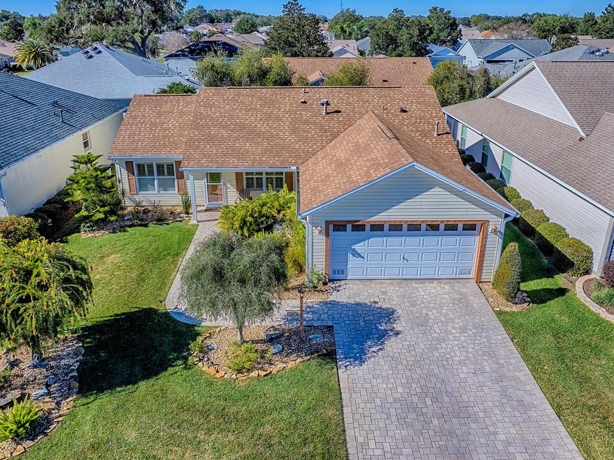 GORGEOUS, UPDATED & IMPECCABLY MAINTAINED - 2 Bedroom/2 Bath home with a Spacious 2 CAR GARAGE - Conveniently located between 466 & 466A in the VILLAGE OF BELVEDERE, just MINUTES AWAY FROM LAKE SUMTER LANDING.  ROOF 2021, HWH 2021, AC updated 2016.  As you arrive, you will notice GREAT CURB APPEAL with PAVER DRIVEWAY & WALKWAY, TERRIFIC LANDSCAPING including a 'Low Maintenance' Zen-like WATER FEATURE creating visual interest, beauty and calming sounds of a babbling brook!  The Abilene Floor Plan offers a LIGHT, BRIGHT & OPEN Concept with Vaulted Ceilings, Solar Tubes & Split Bedrooms.  There is a Spacious White Kitchen (with Gas Stove, a Center Island, plenty of Cabinet /Counter Space) adjoining the Dining Room and Living Space.  Ceramic Tile Floors throughout the Main Living area & Bathrooms with Laminate Flooring in the Bedrooms.  The GLASS ENCLOSED LANAI offers extended living space, has Epoxy Flooring and is surrounded by PRIVACY SHRUBS.  A generously sized birdcage is located off the lanai for outdoor grilling and dining. Some Additional Features & Updates: Plantation Shutters, Recently Painted, New Sliding Glass Lanai Doors, New Light Fixtures, Fans, Bathroom Fixtures, Mirrors, Hardware, Kitchen Pullouts, Epoxy Floors - Lanai & Garage, Smoke Detectors, Seco purchased 15 yr Warranty Surge Protectors, etc..  The Village of Belvedere includes three executive golf courses that play in and around this quaint neighborhood. They can be traced back to the Pimlico Village Recreation Center, where you'll find a family swimming pool, horseshoes, bocce, shuffleboard, pickleball and tennis. Residents enjoy terrific ways to spend time in the Florida sunshine, but also know that some days may be better spent indoors. Inside and you'll find a billiards room, meeting rooms just right for your favorite club, and even kitchen facilities for those neighborhood get-togethers. For the closest spot to have some fun, try the Belvedere Recreation Center, featuring an adult pool - a great place to meet all your new neighbors. **Turnkey &/or Furniture Package Available Separately, also there is a 2013 Yamaha Golf Cart Available Separately**