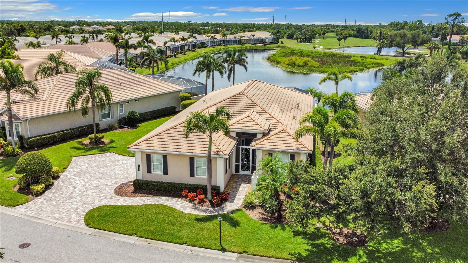 You will fall in love with the panoramic water and golf course views from this beautifully furnished/turnkey Estate Home nestled in the welcoming community of St. Andrews East at The Plantation Golf & Country Club. This Kensington Model is a 3-bedroom, 3-bath home with an additional den and offers sweeping views of the lake and golf course from nearly every room. Professionally decorated and offered turnkey furnished, this home is truly move-in ready with high-end, quality furnishings throughout.
The open floor plan is filled with natural light and features tray ceilings, crown molding, and plantation shutters for an elegant Florida feel. The spacious kitchen offers abundant cabinetry, a breakfast bar, and a cozy eating area—all perfectly positioned to take in the tranquil water views. The great room flows seamlessly to the screened lanai through sliding glass doors, creating the perfect indoor-outdoor lifestyle.
The expansive primary suite features two walk-in closets with custom organizers and an en-suite bath with dual vanities and a walk-in shower. Guests will enjoy total privacy with two generously sized guest bedrooms, each with its own en-suite bath. The den offers a quiet retreat with built-in shelving and desk, ideal for working from home or enjoying a hobby. New HVAC System 2025.
Storm-ready, this home features impact hurricane glass windows and roll-down hurricane shutters on the lanai, giving you peace of mind in just minutes. The low HOA includes lawn maintenance, and best of all—there’s NO CDD fee.
The side-load, two car garage includes custom storage and has been immaculately maintained.
Residents enjoy access to an active clubhouse and two community pools. Optional membership to The Plantation Golf & Country Club provides access to two 18-hole championship golf courses, 13 Har-Tru tennis courts, six pickleball courts, bocce ball, a Jr. Olympic pool, fitness center, and a full calendar of dining and social events.
Located just minutes from Gulf beaches, shopping, dining, Wellen Park Downtown, the Atlanta Braves Spring Training Stadium, and I-75, this home is the perfect blend of elegance, comfort, and convenience—offering the very best of Florida living.