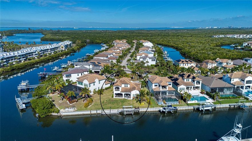 New Price!  $55,000 price adjustment!  Luxurious WATERFRONT home featuring a composite boat dock with lift, additional 32’ floating aluminum dock, and one of the largest premium lots with an expansive 133 feet of shore line is now available in the highly sought resort community of Little Harbor. The deep, sailboat water of Little Harbor is a boater’s dream with quick access to the Bay and Gulf with no lifts or bridges.  Upon entering the home the first thing that greets you is the expansive, breathtaking water views from the Great Room. The home’s versatile open floor plan featuring sand colored, wood flooring is perfect for entertaining a large gathering of family and friends as well as more intimate settings. The spacious kitchen is a chef's delight with a gas cook top, quartz countertops, extensive storage cabinets with under mount lighting, pantry, and an oversized center island with plenty of inviting seating available. From the living area, the large, private lanai with outdoor kitchen and seating beckons. Enjoy the soothing water views each morning, afternoon, and evening with a beverage of your choice as the variety of birds as well as the dolphin and manatee entertain. The first floor also features the primary bedroom with an electric fireplace and ensuite bathroom, a half bath, laundry room, dining area and a flex space that can also be used as a formal dining room.  As you take the stairs or choose the convenient 3-stop ELEVATOR to the second level, the additional bedrooms do not disappoint. This floor not only offers additional size in the form of a large loft, but a desirable spacious, covered terrace for enhanced, sweeping views of the waterfront and sunset skies. This premium, oversized waterfront lot is large enough for a significant sized pool. The Seller hired a certified engineer to draw plans, which were submitted and approved by the Architectural Review Board and can be shared with the home’s new owner.  For the car enthusiast, with 12’ ceilings the split 3-car garage can easily accommodate twice as many cars with the addition of lifts.  Additional electrical was also added to house a generator. The extensive amenities exemplify the spirit of the Florida lifestyle offering a clubhouse, fitness center, social/game rooms, pool with waterfall, tennis and pickle ball courts, bocce, an onsite white sand beach with water sports rentals, 2 restaurants, 2 marinas with Freedom Boat Club options, a playground, a newly constructed fishing pier and fishing charters. There is only "one" Little Harbor - offering an onsite beach, marinas, restaurants, a hotel, and so much more on one property. Shopping, restaurants, medical facilities, are all nearby with Tampa, St. Petersburg, and Sarasota within a 30-45 minutes drive.  Even Disney World is near by within about a 90 minute drive to take advantage of "The Magic Kingdom, where dreams come true".  Don’t miss this unique opportunity to enjoy the Florida Coastal lifestyle.  Make your appointment to view today!