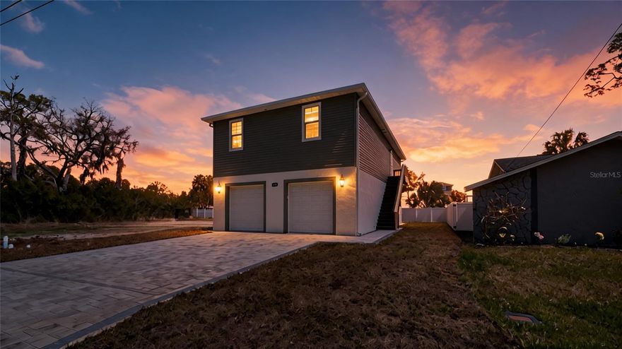 Brand New Coastal Stilt Home with 4+ Car Garage ONLY one block from the main Hernando Beach boat Ramp and Gulf Access! Welcome to your dream home in beautiful Hernando Beach. This brand-new 3 bedroom, 2 bathroom elevated coastal stilt home offers the perfect combination of modern design, functional space, and the relaxed Florida waterfront lifestyle. This NEW CONSTRUCTION home comes with a  This unique property in  the area's most desirable coastal communities. Located just minutes from the public boat ramp with direct access to the Gulf, this home is ideal for boaters, anglers, and outdoor enthusiasts who want to enjoy everything Florida living has to offer. Durable composite wood stairs provide access from both the garage and exterior entry. Inside, the open great room floor plan showcases 9-foot ceilings and luxury vinyl plank flooring throughout, creating a bright and modern living space that flows seamlessly for everyday living and entertaining. The gourmet kitchen is beautifully appointed with a large center island, quartz countertops, stainless steel appliances including a built-in microwave and refrigerator, custom subway tile backsplash, a cast iron farmhouse sink, wood cabinetry, a built-in desk area, and a spacious pantry offering abundant storage. The dedicated laundry room includes cabinetry along with a front-load washer and dryer for added convenience. The guest bathroom features a tub and shower combination with stunning floor-to-ceiling custom tile. The spacious primary suite includes a huge walk-in closet and a luxurious en-suite bathroom with extensive cabinet storage and a beautifully designed floor-to-ceiling tiled snail shower. The expansive 4+ car garage spans the entire footprint of the home and offers incredible storage for boats, vehicles, golf carts, and recreational equipment. The garage features 8-foot garage doors, a 10-foot ceiling, bright LED can lighting, ceiling outlets, and a pre-wired 220-volt outlet for electric vehicle charging, making the space both functional and future ready. Additional features include hurricane impact windows and elevated construction for added peace of mind. With three lots included, the property offers endless possibilities for additional parking for boats or RVs, space for a pool, future guest house or garage, outdoor entertaining areas, or simply extra privacy and room to expand. Estimated homeowner's insurance is approximately 1,362/year and flood insurance is approximately 3,520/year.  Life in Hernando Beach offers an exceptional coastal lifestyle with boating, kayaking, paddleboarding, and fishing right nearby. Residents are also just minutes from the natural beauty of Weeki Wachee Springs State Park and conveniently close to shopping, dining, hospitals, and top-rated schools. The community is golf cart friendly and offers the rare benefit of no HOA and no deed restrictions, while allowing short-term rentals, making it an excellent option for full-time residents, seasonal snowbirds, or investors. Easy access to the Suncoast Parkway provides convenient commuting to Tampa, Brooksville, and surrounding areas. This move-in ready new construction home offers space, style, and location in one of Florida's most desirable Gulf access communities. IF YOU WANT MORE LAND you can INCLUDE THE TWO ADDITIONAL LOTS AND PURCHASE THE HOME and 2 ADDITIONAL LOTS FOR 475000 dollars.