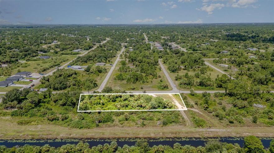 Rare opportunity to own 1.1622 acres - in the thriving community of Lehigh Acres. Set in a quiet, rural location, the property backs up to a canal, providing a serene water view and a natural buffer with no rear neighbors, for added privacy. This unique property is made up of five contiguous parcels - sold together - that could be easily split into 5 separate lots, each 81 feet wide, offering incredible flexibility to build your dream home, a family compound, or multiple residences. Here, you can design a custom-built home with plenty of space for a pool, outdoor living area, and more - without the restrictions of an HOA. Enjoy the peacefulness of Lehigh Acres while staying close to modern conveniences. Located just 40 minutes from Fort Myers and 20 miles inland from Fort Myers Beach, you’ll have easy access to the area’s beautiful coastlines and amenities. Lee County offers an abundance of outdoor activities, from Harn’s Marsh and Trailhead Park to horseback riding trails and numerous golf clubs. Whether you’re looking for a private escape or a smart investment in one of Southwest Florida’s fastest-growing communities, this property delivers both privacy and potential.