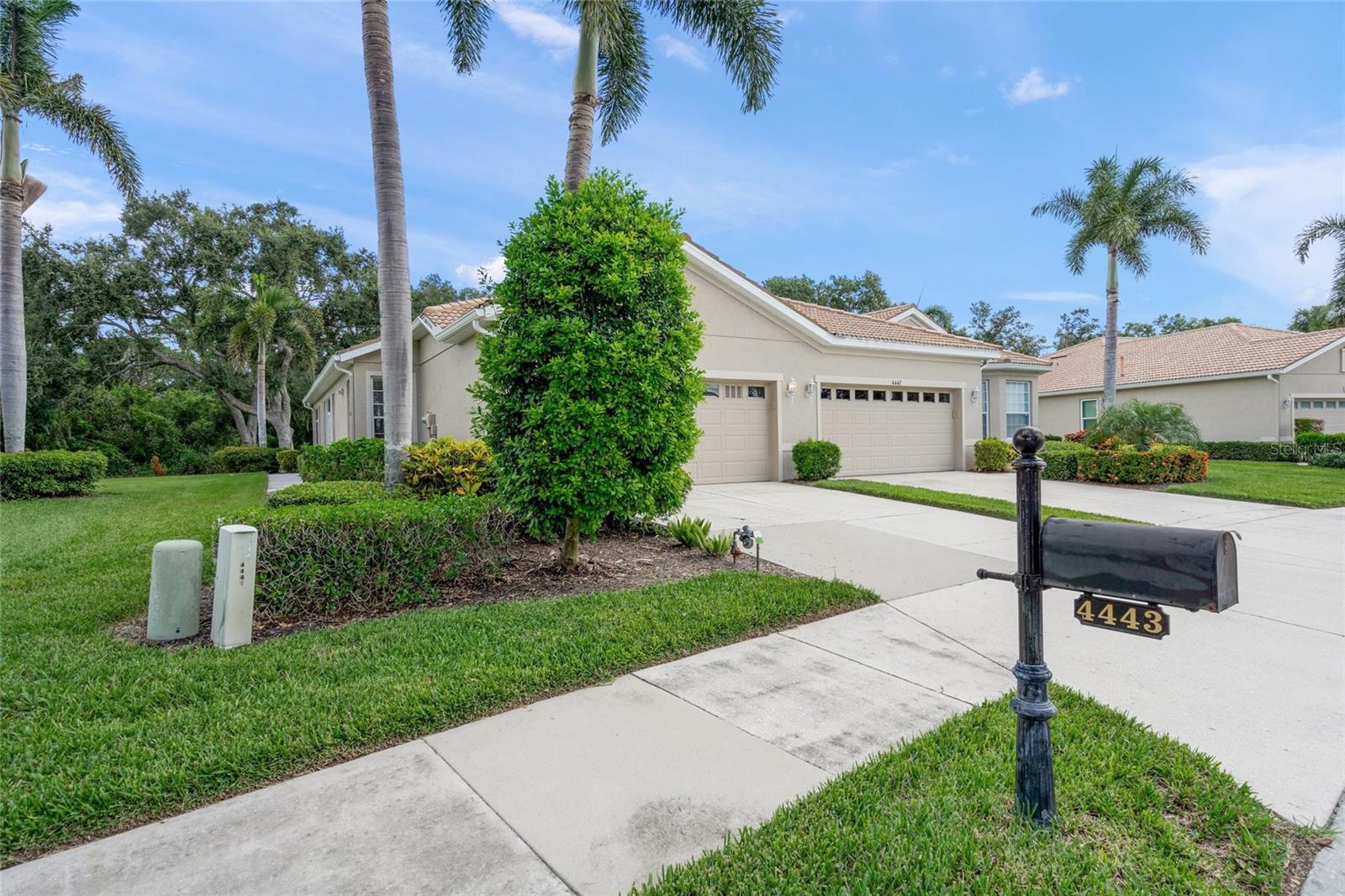 Located in the sought-after 55+ gated community of Lakeridge Falls, this meticulously maintained paired villa presents a perfect combination of comfort, low-maintenance living and resort-style luxury—an ideal choice for your next chapter. The Victoria floor plan features two bedrooms plus a den (with potential conversion to a third bedroom), a spacious living and dining area, an eat-in kitchen, laundry room, covered screened lanai, generous storage space, and a two-car garage. The split bedroom layout ensures privacy, with the primary suite offering two closets (one walk-in) and an en-suite bathroom equipped with dual sinks, a walk-in shower, soaking tub, and water closet. The guest bedroom with a walk-in closet is conveniently located near the second full bathroom, while the laundry area boasts a newer washer and dryer, utility sink, and built-in cabinetry for enhanced functionality. The upgraded kitchen showcases quality wood cabinetry, Corian countertops, a pantry, and a comfortable breakfast nook. Enjoy tranquil mornings or relaxing afternoons on the screened lanai, which provides a private, nature-filled view. Recent updates include fresh interior paint, a Lennox A/C system installed in 2018 (with 2.5 years remaining on the warranty), a new water heater (2023), and a new refrigerator (2024). Lakeridge Falls encompasses 399 homes across 170 acres featuring 16 scenic lakes, preserved green spaces, extensive walking paths, and well-kept landscapes. Residents have access to extensive amenities, such as a recently renovated clubhouse, resort-style heated pool with lap lanes, spa, fitness center, kitchen, card room, computers, library, ping pong and pool tables, bocce ball courts, and a picturesque sand beach. An array of social opportunities—from bingo nights, clubs to educational events—enables residents to participate in activities based on their interests. The community's prime location offers proximity to shopping and dining along University Parkway including UTC Mall, and quick access to I-75, SRQ Airport, downtown Sarasota and world-famous beaches.