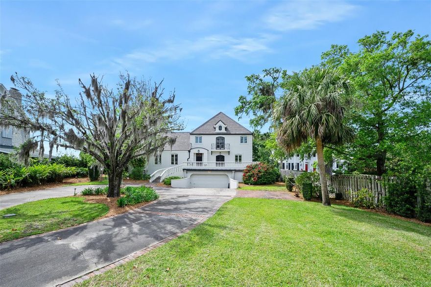 Custom waterfront estate home with guest house and deep water dockage situated on 1.2 Acres of land high above the Halifax River. This fabulous home has just received a ''no stone unturned'' renovation where the owners demanded the absolute best in appointments, products, and construction techniques. The designer perfect finished product presented to you today is the result of a lengthy project that cost in excess of $1 million and it truly must be seen in person to be appreciated. As you approach the main home down a long winding drive, past the guest house, you will find yourself at the base of a lovely curved staircase of formed concrete that carries you to the sprawling morning terrace that sits just east of the front door. Enter the home and into the grand foyer before stepping into the spectacular waterfront parlor where a limestone fireplace sits beneath soaring cathedral ceilings with handsome wood beams. 
Three sets of mahogany French doors with glass panes allow for fantastic views of the water. Open them up and allow indoors and outdoors to become one with the waterfront lanai that serves as the outdoor living and dining space beneath a canopy of ancient oak trees. A fourth door on the lanai opens into the waterfront kitchen which was designed to function as the ultimate chef's space and double as an entertainment and relaxation space with panoramic views. The kitchen leaves nothing to be desired with top of the line appliances set into solid wood custom cabinetry appointed with a stunning selection of quartz. The main home features four bedrooms plus office and three and 1 half baths including a terrific waterfront primary suite with private waterfront balcony, magnificent luxury bath and walk-in closet. A second waterfront suite with a private bath is adjacent and shares commanding top floor views of the water. Downstairs, two sizable guest rooms are drenched in natural light and share a lovely new bath. Garage space was a priority in the original design and the main home features a garage that measures 35' x 24', however the detached, air conditioned collectors' garage just across the drive measures 37'x 25' with lovely showroom floors and a half bath. An interior stairway leads to the complete two bedroom guest home with kitchenette and a charming bath. Guests can open beautiful french doors to take in views of the gardens in the shade of an impressive orchid tree that blossoms deep purple blooms each spring and listen to the waves crash the shore from the Atlantic Ocean just three blocks to the east. The deep-water dock was recently constructed by the highly regarded, third generation marine contractors at Custom Built Docks with two 20,000 lb boat lifts. Ideally situated on a deep water shoreline within the no-wake zone.