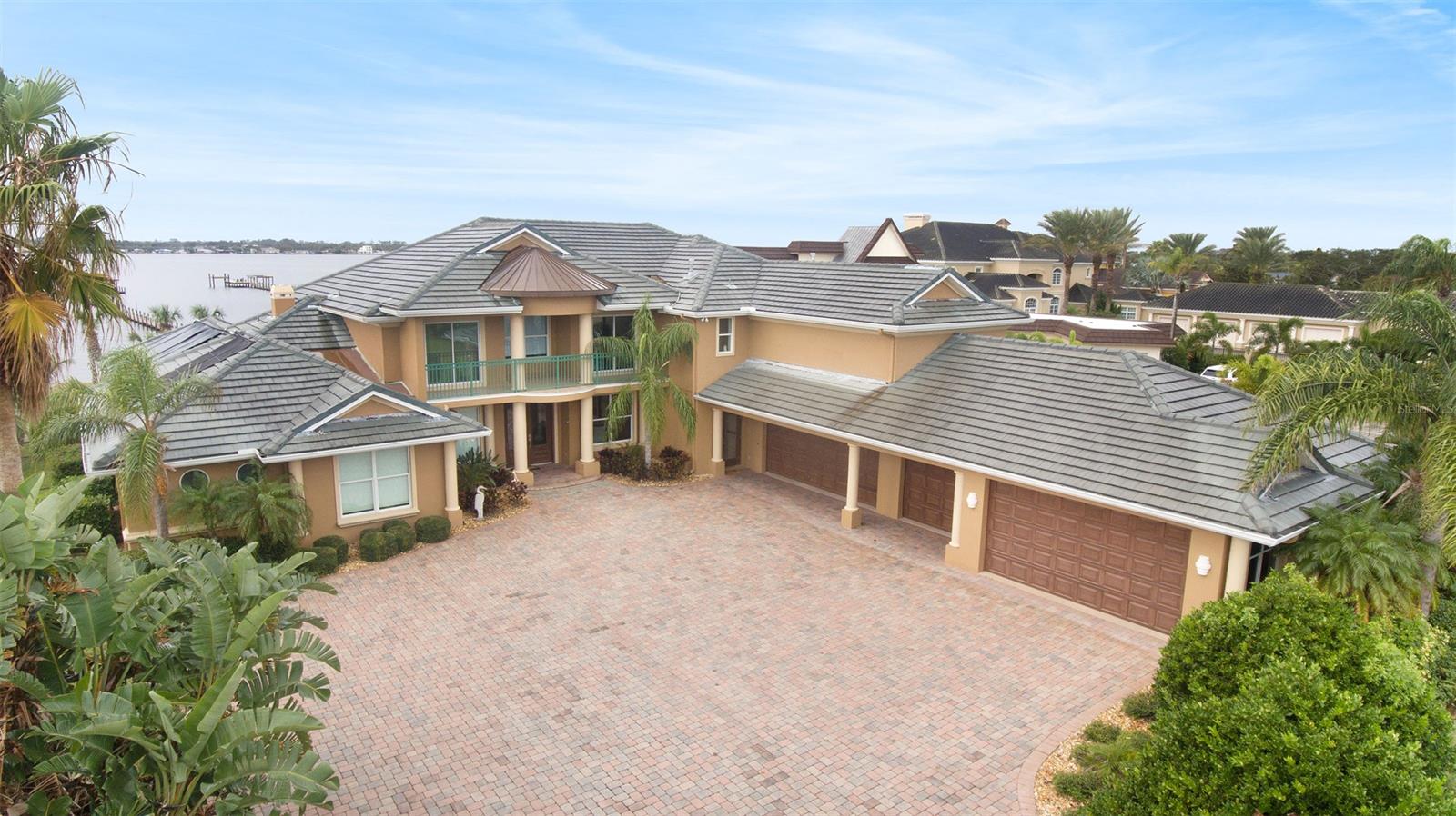Relax and enjoy the view in this luxurious riverfront, custom home! This estate is over 9,000sqft of luxury, consisting of 6,400sqft under air, with 5 bedrooms and 7 bathrooms (4 of which, being full baths). Take a short walk, around the block, over to the beach to watch the sunrise; or lay in bed, in either of the two master suites and enjoy the breathtaking view of the intercoastal. Entertain your guests inside and out, watching the beautiful sunset over the water, in every room of the home. Take it outside, onto the luxurious covered patio, consisting of a summer kitchen, outdoor shower and a beautiful and elegant pool/spa! Formal Living Room, Formal Dining Room, Family Room and an additional recreational room on the river. Large custom kitchen with two islands. Home office could be utilized as a den or a 6th bedroom. The fishing is amazing off the dock: catch snapper, shark, trout, flounder and many of types of fish. Dock has SSL allowing 5 boats and has two large benches for entertaining/relaxing. The home being set right in the middle of roughly an acre and a half, has more than enough room to add a fifth garage, or even tennis courts! Truly impressive home and will not disappoint! ;Water: City