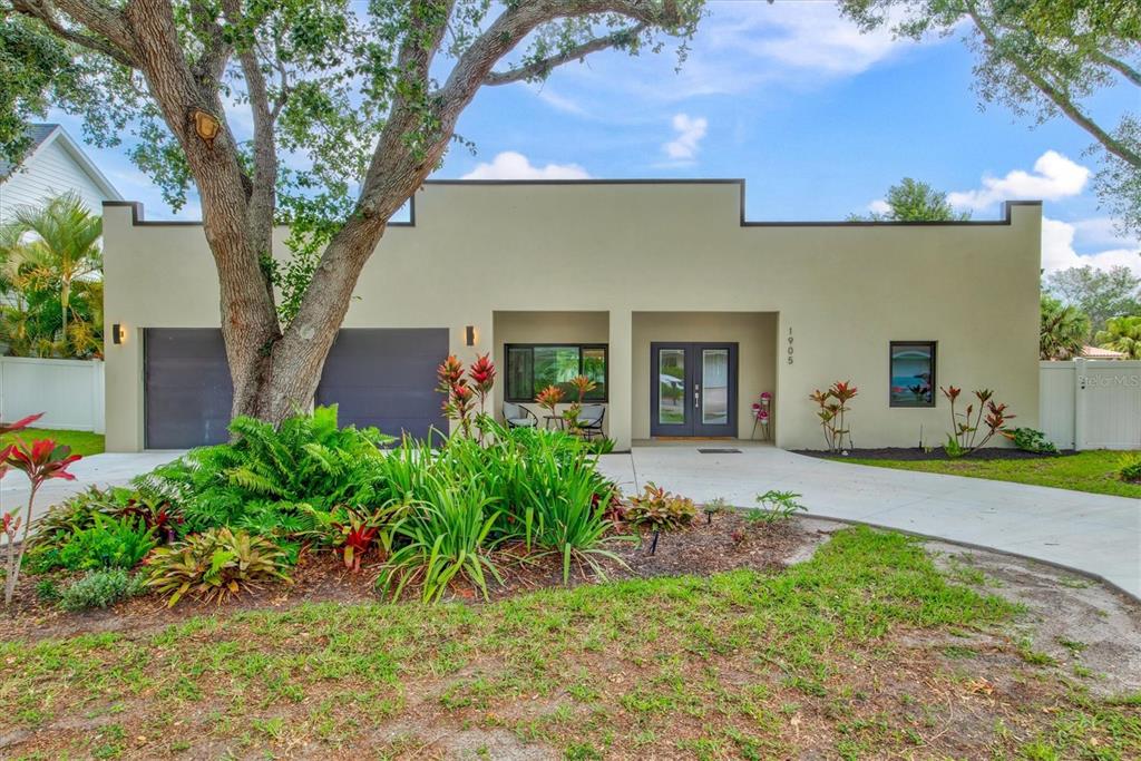 Welcome to the Siesta Stunner! This 1950s pool home has been completely remodeled down to the studs w/ designer finishes & furnishings & high ceilings throughout. A short walk or bike ride will get you onto Siesta Key & the house is walkable to both Publix & the Siesta Key Mall! The space is light and bright thanks to the 10ft ceilings, abundant windows and southern exposure. Upon entering the home the entire living space is in front of you with a true open concept floor plan. To the left is an open dining area with seating for 6. Beyond the dining area is the great room which has been appointed with designer furniture and conversational seating for 8 guests. On one side of the great room is a separate media room with sectional sofa and 60 inch tv offering streaming services on a smart tv. On the other side of the great room is the cheerful kitchen with all new SS appliances and quartz counters and bar stool seating for 4. On the East wing of the house are two bedrooms with a shared bath. Bedroom 1 offers a king size bed and two night stands while bedroom two offers two twin beds with a nightstand between them. On the West wing of the house is the oversized master suite which offers a designer spa-like bathroom with his and her sinks and a subway tile walk-in shower with seamless glass enclosure. Across from the bathroom is a walk-in closet large enough to park an SUV. The master bedroom offers a dedicated workspace with large flatscreen above and a sitting area with two chairs looking out onto the pool. A laundry room with washer and dryer and additional storage space completes the West wing. The party is in the back at the Siesta Stunner with a fully fenced backyard that features an all new heated pebble pool. 4 lounge chairs and an umbrella are available on one side of the pool deck and an outdoor dining table, a bbq grill and additional seating for 4 can be found on the other side. Additional sleeping area can be found in the media room on the blue couch shown in photos. This is a short term vacation rental and can be rented weekly or monthly based on availability.