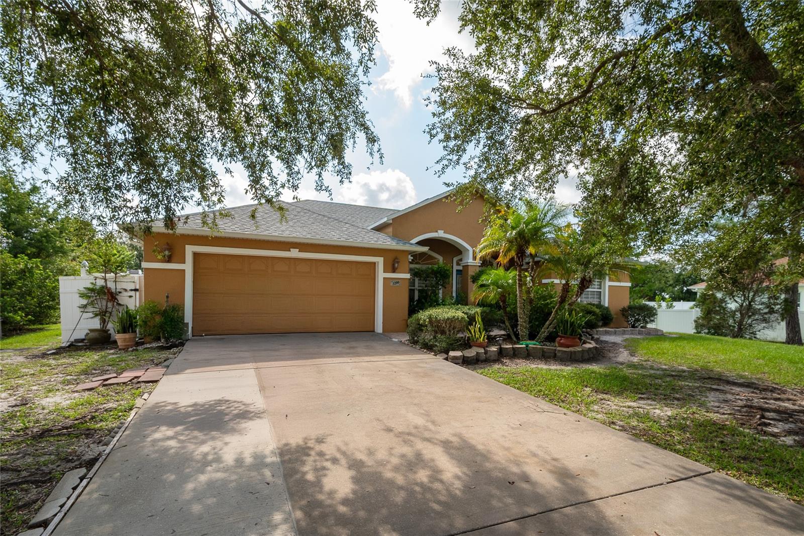 Welcome to this beautifully updated 3-bedroom, 2-bathroom lakefront home featuring a private pool oasis. From the moment you walk in, you’ll notice the spacious open floor plan with high ceilings, recessed lighting, and elegant marble-look tile throughout the main living areas. The remodeled kitchen is the heart of the home, showcasing granite countertops, stainless steel appliances, sleek cabinetry, and a large island perfect for family gatherings and entertaining guests. The master suite is a true retreat, offering tray ceilings, ample closet space, and a spa-inspired bathroom with a soaking tub, walk-in shower, and dual-sink vanity. Step outside to your private backyard paradise where a sparkling pool is surrounded by lush tropical landscaping, creating the perfect setting for relaxation or entertaining. Beyond the pool, enjoy the serene lakefront views and peaceful atmosphere that make this home truly special. Additional highlights include a two-car garage, dedicated laundry room with utility sink, and a spacious lot with mature trees and privacy fencing. Conveniently located near shopping, dining, and major highways, this home combines comfort, style, and Florida living at its finest.