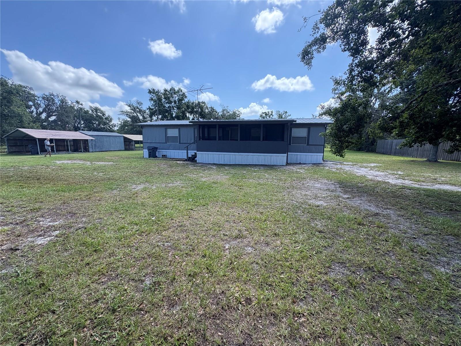 Move-In Ready Home on 2.86 Acres – Rare Opportunity!
Opportunities like this don’t come along often! This like-new 3 bedroom, 2 bath manufactured home sits on a gorgeous 2.86-acre fenced lot featuring a pond and gated entry—offering the perfect blend of space, privacy, and convenience. Recently remodeled, the home boasts brand new carpet, vinyl flooring, fresh paint throughout, and numerous upgrades including a new AC, updated well components, and fresh exterior paint with new skirting. Enjoy peaceful mornings on the large screened front porch, and take advantage of the two carports and spacious shed with new shingles for added storage and functionality. The property is on a well and septic system (with a new sump pump), and best of all—there’s no HOA. Located in Flood Zone X (with only a small portion of the rear in Flood Zone A), this home offers peace of mind and flexibility for future use. Whether you're looking for a quiet retreat, space for animals, or room to grow, this property has it all!