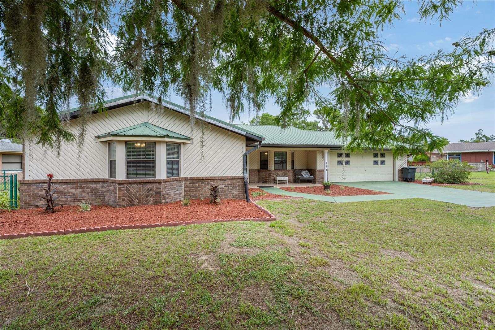 Welcome to this lovely, well-maintained 3-bedroom, 2-bath home situated just outside the charming town of Williston, Florida. Enjoy peaceful living with easy access to Gainesville, Ocala, Crystal River, Chiefland, and the entire Nature Coast—making this the perfect balance between convenience and quiet countryside charm. Inside, the open-concept layout creates a bright, airy flow from the expansive living area to the large, fully updated kitchen. The kitchen features brand-new stainless steel appliances, plentiful soft-close cabinets and drawers, and ample counter space—perfect for both everyday meals and entertaining. The primary suite is a true retreat, featuring beautiful herringbone-patterned flooring, a spacious walk-in closet, and a luxurious en suite bathroom with a huge walk-in shower. This thoughtfully designed home also includes: A separate office and flex space for remote work or study that could even be converted to a 4th bedroom, A large laundry/mudroom, A spacious garage with built-in storage closet, Metal roof for long-term durability and low maintenance, several bay windows that allow lots of natural light to fill the space. Recent upgrades include HVAC in 2022, new appliances 2023, new well pump and pipes 2018 and new drain field 2019. A wall of French doors and windows that open to a large fenced backyard and views of a golf course currently under renovation. Outdoors, you’ll find a generous patio, playground equipment, and plenty of space for kids and pets to play safely in the secure backyard. This move-in-ready home offers everything you need for comfort, style, and functionality—all in a peaceful, family-friendly setting.