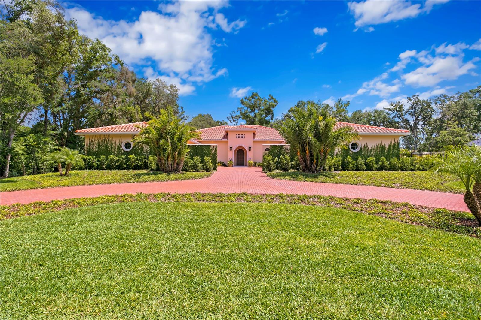 Step into the world of luxury living in this NEW CONSTRUCTION, MOVE-IN READY custom residence located in Tampa’s Avila Golf & Country Club, known for its resort lifestyle and privacy. The authentic architecture is based on the historic mansions of Palm Beach. The builder personally oversaw the construction and used only the finest, top-tier materials and best craftsman. The 3/4 acre private homesite was selected since it is optimally located with only one neighbor and surrounded by concrete walls and private conservation. This high-performance home has top-percentile energy results and the meticulous construction standards. The structure is 100% concrete block. The windows are hurricane-rated and very energy efficient. The roof is durable Mediterranean tile. The upgraded Carrier AC includes dehumidification and filtered fresh-air. The extensive insulation includes spray foam attic and walls to ensure optimum comfort and efficiency. Upon arrival, you are greeted by a custom designed metal entrance door and the open floor plan which flows seamlessly to your resort-style pool and spa creating a harmonious blend of indoor and outdoor living. The home is 7,194 sf with 5,028 sf of living space and additional 2,166 sf of covered entertaining areas. The one-story floorplan includes 4 spacious bedrooms (including 2 suites), 5 bathrooms, home office, gym/flex room, laundry room with stacked washer/dryers, outdoor kitchen, and spacious 6-car garage. In addition to being breathtaking, the gourmet kitchen is an entertainer’s dream. Cabinets are custom designed and some include motorized operation. The custom island was engineered to float above the floor and includes custom lighting. Book matched quartzite counters and full height backsplash were hand selected. Top-of-the line True, Miele and Bosch appliances are included. The secondary Chef’s Kitchen is both functional and assures perfect organization. The area includes a 42” Monogram side-by-side refrigerator, 27” Monogram oven, secondary Bosch dishwasher, 30” Ruvati workstation sink, and custom cabinetry. The Owner’s Suite is the perfect sanctuary for relaxation and enhanced well-being. The spa-inspired Owner’s bathroom includes a Turkish marble shower with full height glass enclosure for steam use, separate vanities with flanking custom stained cabinetry, oversized water closet, authentic Finnish Sauna, and a sunken soaking tub with imported rocks. An oversized master closet can be designed to fit your unique style (includes a hidden room). 3 additional ensuite bedrooms with walk in closets complete the home. Each bathroom has floating cabinetry, marble and quartzite counters, and premium tile and fixtures. The floorplan is complete with a Home Office and a Gym/Flex Room that can be converted to a 5th bedroom with its own bathroom. The 6-car garages are showroom quality. The outdoor living space is magnificent and includes a modern oversized salt water pool, sunken hot tub, oversized sun shelf, entertaining sun deck, and private pool bathroom. While enjoying the resort-style pool, you will love the outdoor kitchen and bar which includes a 36” Alfresco gas grill, True refrigerator and Scotsman gourmet ice maker. If you are looking for the best quality and design, it is worth a tour to see things firsthand. We invite you to tour this move-in ready Avila estate home.