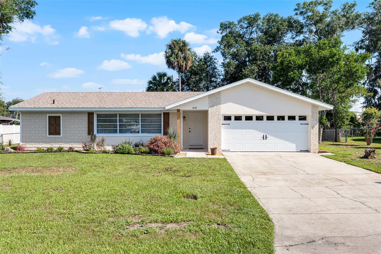 Fully renovated and truly turn-key, this 4-bedroom, 2-bath DeLand home is ready for its new owner! Step inside to discover a spacious living area highlighted by a large picture window that fills the space with natural light. The open layout flows seamlessly into the kitchen, featuring sleek stone countertops, stainless steel appliances, and a dining area ideal for family meals or entertaining guests. The split-bedroom floorplan provides privacy in the primary suite, complete with an updated vanity and a modern stand-alone shower. On the opposite side of the home, you’ll find three additional bedrooms and a full bathroom with a tub/shower combo—perfect for family or guests. Sliding glass doors lead you to your own private outdoor oasis. Enjoy the sparkling screened-in pool and spa, a covered patio for lounging or dining, and a large fenced yard offering plenty of space to relax, play, or entertain. Located in the desirable Live Oak Park community with no HOA, sitting on over a quarter acre, this home is just minutes from historic downtown DeLand, local shopping, restaurants, and has convenient access to I-4—making it easy to reach the Orlando attractions to the west or the beaches to the east. Don’t miss the opportunity to make this updated pool home yours!