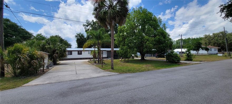 Fully furnished and move in ready this 2 bedroom 2 bath home is ready for a new owner. Located in Kenansville, Fl just thirty minutes south of Downtown Saint Cloud, this home can be a primary residence or a vacation spot, Snow Birds are welcomed! Home sits on just over a .25 acre, with a partially fenced backyard and 2 driveways, which is perfect for RV or boat storage. No HOA. Private, quiet street and walking distance to the Marina. Enjoy your morning coffee and bird watch on the enclosed, screened front porch. Split floor plan with lots of natural light. New metal roof. 2 outdoor storage sheds. Eat in kitchen with a built in desk. Open concept living room/kitchen combo. Indoor laundry with full sized washer and dryer. BONUS ROOM that can be used as a Florida room or a 3rd bedroom or guest bedroom with private access. Bonus room has its own a/c unit and refrigerator. Remodeled 2nd bathroom with upgraded vanity and flooring. Florida living for under 200K!
