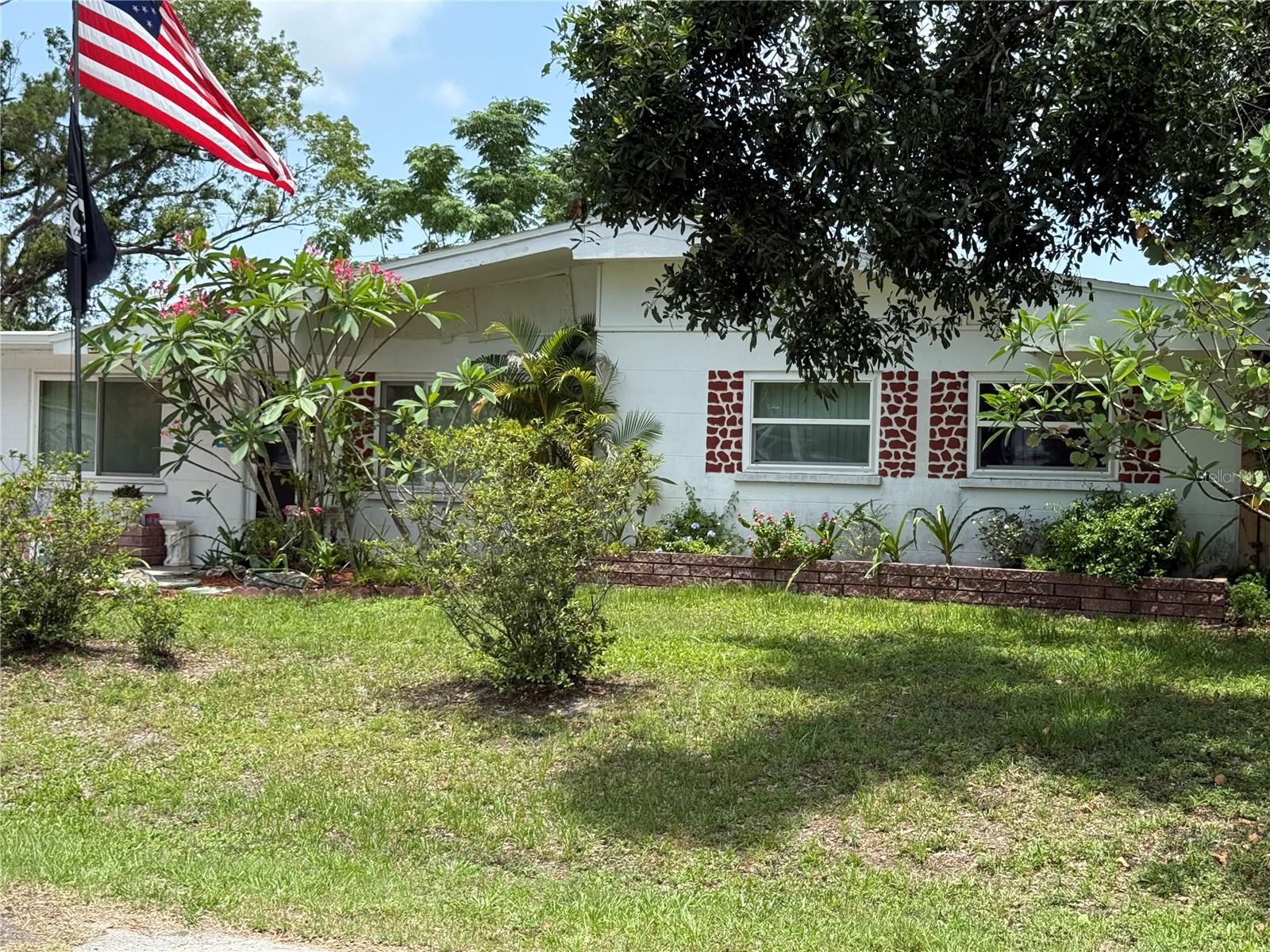 Looking for the large family home? You have found it! This updated 4 bedroom, 2 bath with extra large family room & pool is ready for a new owner! Home has new roof, new storm windows throughout home & newer patio around pool and new flooring inside.
The home has a living room in the front with 3 bedrooms & bath with tub & shower, then large kitchen with door to patio outside, also separate dining room with lots of closets, master bedroom with walk in closet, 2nd bathroom features walk in jacuzzi walk in tub and extra large family room with separate entrance that could be used for mother in law space. All this on 2 fenced in lots. With a 3rd lot available for sale next door. Home is centrally located, minutes to shopping, restaurants and hospitals. Minutes to St Pete and Beaches! Seller is motivated moving to north Florida and ready to sell!