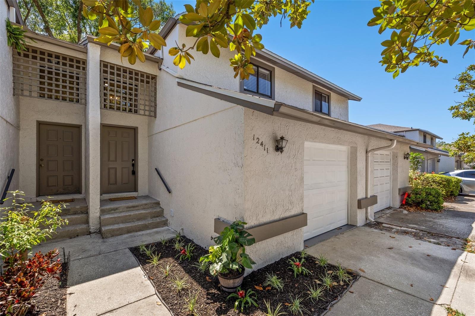 Welcome to your charming 2-bedroom, 1.5-bathroom townhome situated near USF. This two- story offers an attached single-car garage and a plethora of upgrades to elevate your living experience. Step inside to discover new vinyl flooring downstairs, complemented by plush new carpeting throughout the second story. Fresh interior paint creates a bright and inviting atmosphere, enhanced by new fans and light fixtures overhead. The kitchen shines with brand new stainless steel appliances and quartz countertops. Relax in the cozy ambiance of the living room fireplace, accented by high ceilings for an airy feel. The half bathroom is located off the kitchen and features a new vanity and toilet. Upstairs, indulge in the luxury of a fully remodeled bathroom boasting a new double vanity, stylish fixtures, quartz countertops, new toilet, and sleek subway tile. Enjoy the convenience of a designated office space or flex space on the landing pad off the stairs, ideal for remote work or study sessions. Storage is abundant with large closets, under stair storage, and a one-car garage for all your organizational needs. Step outside to your fully fenced backyard via the brand new back slider, perfect for outdoor gatherings and relaxation. Admire the fresh plants and landscaping adorning the front of the home, adding to its curb appeal. With HOA fees covering the roof, water, sewer, and trash, this townhome offers a hassle-free lifestyle. Situated close to Busch Gardens, USF, and major highways (I-275, I-75, and I-4), this townhome offers easy access to a variety of attractions and convenient commuting options. Don’t miss the opportunity to own this beautifully remodeled townhome in a sought-after area. AC August 2022 Exterior Paint Nov 2022 Roof March 2022 Water heater 2012