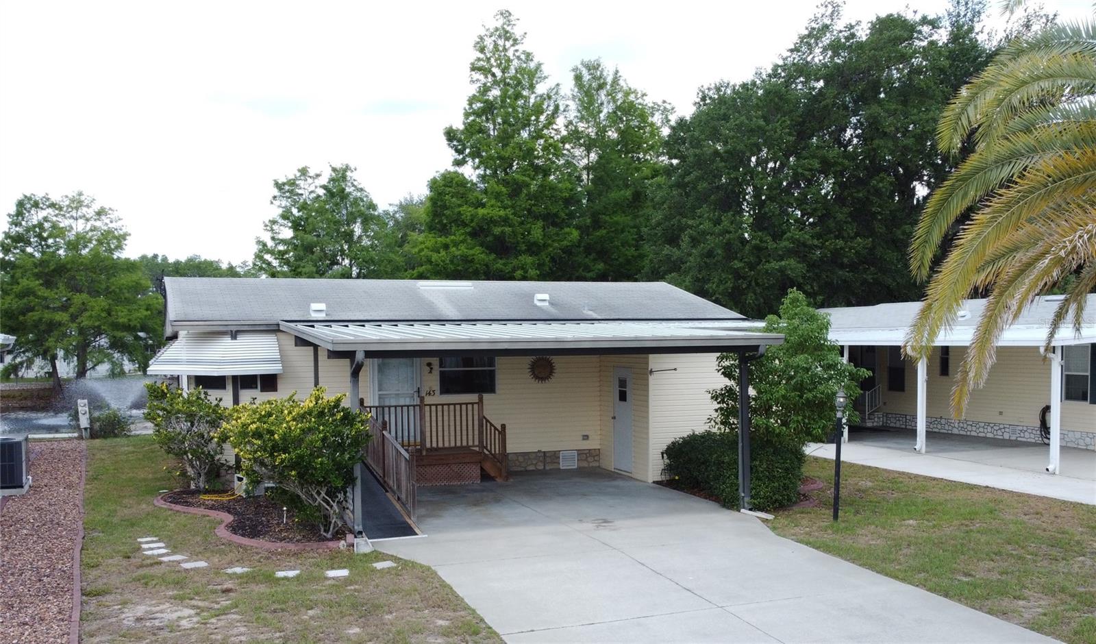 PRICE IMPROVEMENT!!...With both a pond and golf course view, this home sits on one of the best lots in the popular Polo Park West community. This lovely 2-bedroom 2-bath home features a roomy kitchen with loads of cabinet space, solid surface countertops, and a 3-seat breakfast bar! Vaulted ceilings add to the spacious living and dining rooms and there's an enclosed raised lanai off the living room where you can sit and enjoy lovely views of the fountain in the pond and golf course during the day and relax and take in the sunsets at dusk. There is also a fully screened-in cabana off the lanai that offers loads of possible uses. The master suite has dual closets and a walk-in shower while the 2nd bathroom offers a tub in shower. There's plenty of storage space within the large storage shed that's off the 2-car carport and in addition to that there's a golf cart garage in the rear of the home so you can drive right over to the clubhouse and enjoy a round of golf on the beautiful 9-hole course. Other features of this home include a long double wide driveway for extra parking, a ramp access to the front door, a large laundry closet inside the home with additional storage space, laminate flooring in the kitchen, living and dining rooms, and an AC unit that's only 2 years old. The home is being sold with all the appliances and most of the furnishings....All of this in a fantastic location just minutes to Disney and the theme parks, as well as restaurants, shopping, medical facilities and all that Central Florida has to offer. Polo Park West is an active 55+ community with lots of clubs and social activities and has fantastic amenities which include 2 clubhouses, 2 heated pools, a fitness center, a golf course, tennis and pickleball courts, horseshoes, and shuffleboard courts. All of this is included in the very low HOA fee of just $60 per month. Don't miss this opportunity to make this lovely home your winter retreat or your full-time residence!