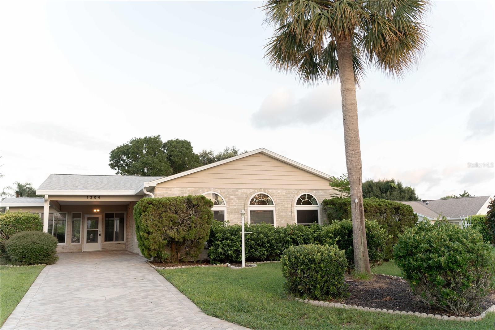 Welcome home to this site-built brick / concrete home nestled in the Village of Del Mar, close proximity to Spanish Springs and Lake-Sumter Landing. AMAZING NEW LOWER PRICE !! This uniquely designed cul-de-sac home has space for all your entertaining and activities with almost 2200 square feet of living space and an additional enclosed lanai and several outdoor areas to enjoy. This home has plenty of storage including several storage closets and pantry in the kitchen. A central cooking station highlights the kitchen. Enjoy music and radio on the surround sound stereo system. A wet bar adjacent to the dining room allows for great entertaining spot - right next to the enclosed lanai to enjoy the outdoor space. This lot is oversized ( over 1/4 acre) and has plenty of room to add on or enhance with a pool/birdcage. The huge primary bedroom has a retreat-style entry so you have your own private TV/sitting/crafting space along with 3 closets - one being equipped with a built-in desk system. Skylights adorn the home providing lots of natural light. The second bedroom has a large walk-in closet and its bathroom is ensuite, yet accessible to your guests as well. Laundry room is separate and has Maytag washer & dryer with tons of storage and workshop space and also an outdoor-style utility sink. You'll love the newer tankless water heater for efficiency. Wood-look laminate flooring and tile in the kitchen and baths along with a neutral color palette provide lots of opportunities to make this special home your own. NO BOND. Roof replaced in 2021. HVAC 2020. This location is 5-10 minutes close to Spanish Springs and Lake-Sumter Landing town centers - and minutes from numerous shopping, dining and health care opportunities.