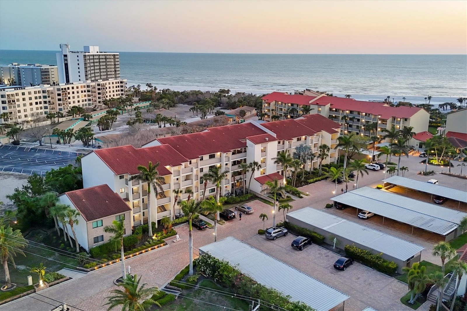 Experience coastal living at its finest in residence #300 at Siesta Dunes, ideally on renowned Siesta Key Beach. This meticulously remodeled two-bedroom, two-bath condominium offers 1,150 square feet of luxurious living space on the third floor, providing a tranquil ambiance and a sense of escape. Crown molding accents the professionally decorated interior, creating a sophisticated atmosphere. Sold turnkey furnished, this residence offers a seamless transition into upscale beachside living. Go inside to find chiseled travertine tile flooring throughout, adding natural coastal charm. The chef’s kitchen is equipped with granite countertops, stainless steel appliances and maple cabinetry, blending style and functionality. French glass doors open to a private lanai terrace surrounded by lush garden views. The lanai is enclosed with hurricane-resistant sliders, while the primary suite features hurricane-resistant windows for added peace of mind. The primary suite also includes a custom-organized walk-in closet, enhancing storage and convenience. A convenient stackable washer and dryer are in the unit. Additional features include an assigned covered carport, a private storage closet, ample guest parking and access to the building elevator. Siesta Dunes is a gated community offering a wealth of resort-style amenities, including a heated pool and spa for year-round enjoyment, a beachside deck, pavilion, clubhouse, and tennis and pickleball courts. Utilizing the on-site property management company makes renting the property easy and carefree. With excellent rental potential, two-week minimum stays from January 15 through the end of April and one-week minimums the rest of the year, this condominium is a compelling investment opportunity as well as a personal retreat. Siesta Dunes is in a good location, making it easy to explore Sarasota’s world-class dining, shopping and entertainment. Siesta Key Beach is just a short distance away, recently named the No. 1 beach in America by TripAdvisor. Renowned for its powdery white sand, clear waters and stunning sunsets, it’s no wonder Siesta Beach is considered the pinnacle of coastal living. Whether you seek a full-time residence, a luxurious vacation retreat or a high-value investment, this extraordinary property exemplifies the best of gulf-front living.
