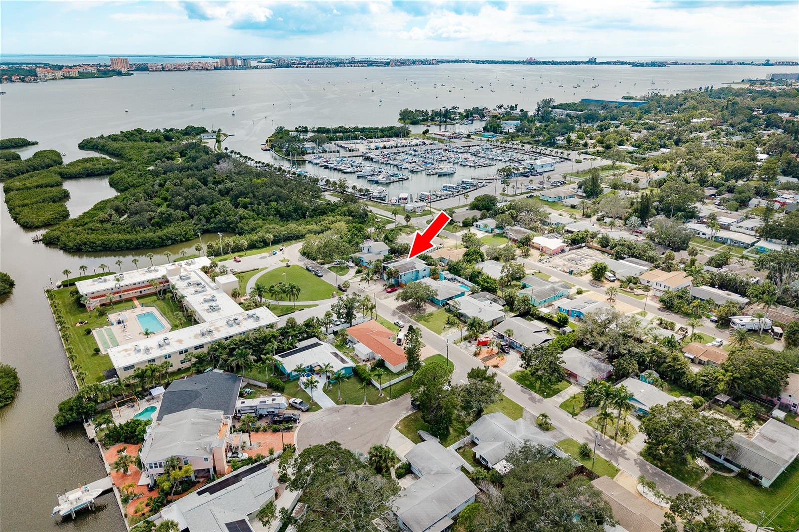DISCOVER EXTRAORDINARY KEY WEST STYLE - stilt home, perfectly situated adjacent to the vibrant Gulfport Marina and minutes from downtown Gulfport. This unique property boasts an artistic flair from the moment you arrive, featuring a custom-designed, lighted staircase with intricate metal sculpture. The main level has just been painted a serene coastal blue complementing the BAMBOO FLOORING throughout. The handsome wood cabinets and shelving system in the living and dining rooms adds a lot of storage. The chef's kitchen features new soft-close cabinets with undermount lighting, GRANITE COUNTERTOPS and stylish tile backsplash with a suite of STAINLESS STEEL APPLIANCES. The split bedroom layout features a primary ensuite bedroom with walk-in closet, double custom vanities, spacious walk-in shower with 2 shower heads and a jetted tub for a relaxing soak. The sunny guest room has a walk-in closet, sliders to the balcony and is adjacent to the second bath also with a tiled walk-in shower. The third bedroom is currently being used as an office but could be yoga studio, craft room or whatever your imagination wants it to be! The lower level BONUS ROOM has been completely renovated with moisture-resistant DUROCK walls and PVC trim and elevated electrical system. A great space for a home gym, pool table or playroom. Safety and efficiency are paramount in this ECO-FRIENDLY home. All WINDOWS and SLIDERS are IMPACT-RESISTANT, it's completely SOLAR-POWERED including the hot water heater, a NEST thermostat was recently installed and the roof was replaced in 2018. Practical features like FRENCH DRAINS and sump pumps and gutters that drain to the pumps provide excellent water management. Enjoy the Florida lifestyle around the POOL with NEW LINER (2024) and solar pump (2024) or up on the deck surrounding sides of the house. Panoramic views of unforgettable sunsets and the marina await up on the widow's walk. STORAGE abounds with an oversized two-car garage, gated RV/Boat storage complete with flood lights, power and water and an elevated shed perfect for an art studio, playhouse or workshop. You're close to beaches, shopping and dining and all the UNIQUE LIFESTYLE THAT GULFPORT OFFERS! This truly is a ONE-OF-A-KIND COASTAL GEM!