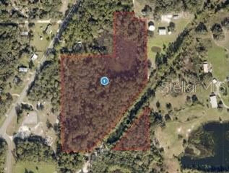 Discover privacy, nature, and opportunity on this beautiful 11.17 acre parcel in peaceful Astor, Florida. Featuring approximately 8.37 acres of high and dry buildable residential land plus 2.8 acres of wetlands for added privacy and natural beauty, this property is ideal for a custom home, family compound or investment.  Enjoy a quiet rural setting just minutes from the St. Johns River, Ocala National Forest, marinas, parks and SR-40 access. Abundant wildlife, no HOA and endless possibilities make this a rate chance to own a large piece of Florida land.
