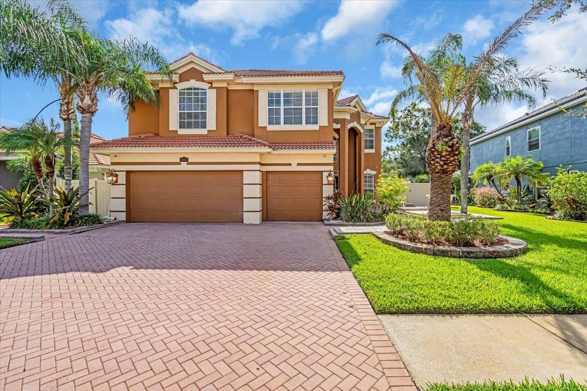 Welcome to 12835 Darby Ridge, a beautifully updated 5-bedroom, 3-bathroom home with a spacious bonus room, offering over 3,550 square feet in a sought-after Carrollwood location, where lush landscaping and a paver driveway welcome you home. A serene front koi pond and elegant tiered fountain create an inviting first impression. Inside, you’re welcomed by an elegant foyer with soaring ceilings and an angled staircase. Brazilian wood and ceramic tile floors flow throughout with no carpet, complemented by fresh 2025 interior paint, crown molding, and detailed trim work. The kitchen boasts custom cabinetry, granite countertops, stainless steel appliances, and two three-panel sliding glass doors—one in the kitchen and one in the living room—both opening to the pool area. Two spacious living areas are complemented by an open formal dining area and a casual dinette. The floor plan offers a first-floor bedroom and full bath with pool access. Upstairs, you’ll find three bedrooms, the spacious primary suite, and a bonus/media room wired for subwoofer and HDMI. The primary suite includes a large walk-in closet, soaking tub, and separate shower. All three bathrooms were remodeled in 2025 with stylish upgrades and beautiful tile work. The two upstairs baths each feature a double-sink vanity. Step outside to your private, screened backyard retreat, featuring a 30-foot heated PebbleTec pool and spa resurfaced in 2021 with a custom waterfall. The 2021 outdoor kitchen includes a Paradise Grill, built-in side burner, sink, and mini refrigerator. Additional features include custom seating near the outdoor kitchen, a second koi pond with a bonsai tree centerpiece, a paver patio, and low-maintenance landscaping. Recent updates include two new AC units (3-ton and 3.5-ton), a 2024 pool pump, and a 2023 water heater. For added convenience, the home offers an inside laundry room and a whole-home water softener. The three-car garage features a freshly painted floor, built-in cabinets, and a wash sink. Low HOA and no flood insurance required. Close to top-rated schools, shopping, dining, major highways, Carrollwood Village Park, and the Carrollwood Cultural Center. This home blends luxury, function, and the Florida lifestyle. Schedule your private showing today—this one will not last.