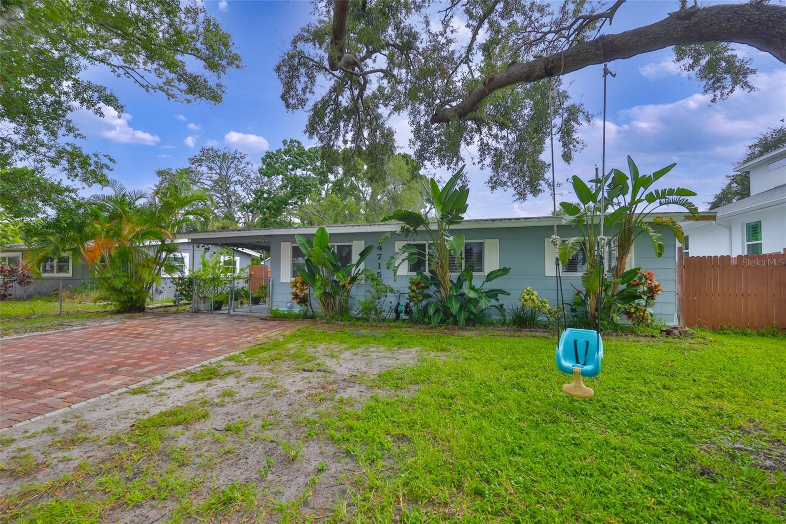 Welcome to this inviting 3-bedroom, 1-bathroom home tucked away between Westshore and Manhattan Blvd. South of Gandy. With its cozy charm and spacious backyard, this property is perfect for those who love both indoor comfort and outdoor living. Step inside to find a bright living room with laminate wood-look flooring and crown molding that adds a touch of character. The kitchen features plenty of cabinet space, stainless steel appliances, and a dining nook with French doors leading to the backyard. Tile flooring runs through the bedrooms and bathroom, keeping the home cool and easy to maintain. The bathroom was recently remodeled with new tile and upgraded gold finishes. The true highlight of this property is the backyard retreat. A large, covered patio with space for lounging and dining is perfect for entertaining year-round, while the lush yard is fully fenced and features tropical landscaping. There is even a large shed for extra storage, and plenty of room to play or garden. Additional features include upgraded windows, the home has been all re-plumbed, the electric panel was updated, there is a one-car carport, a spacious driveway, and charming curb appeal with mature oak trees offering shade and character. Located just minutes from MacDill AFB, Westshore Marina District, and the vibrant restaurants and shops of South Tampa and Hyde Park, this home combines convenience with relaxed Florida living. Although in flood zone AE, this home saw no flooding from last year's storms!