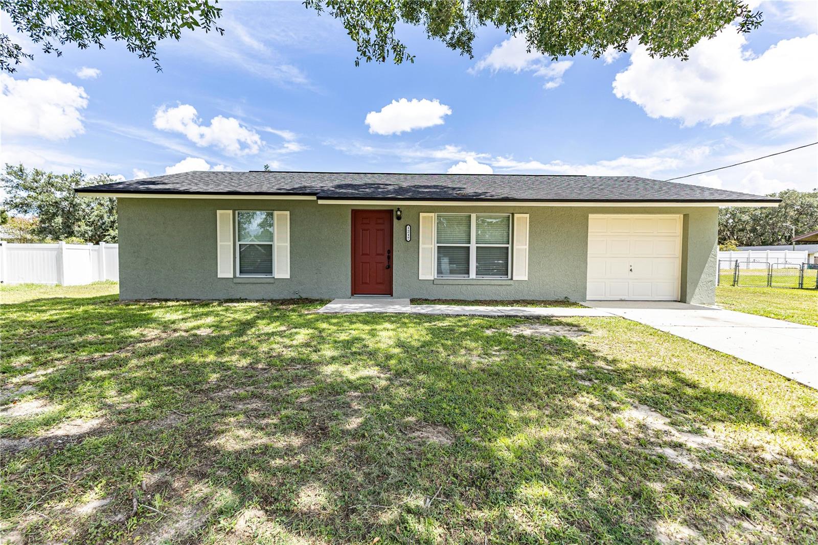 Interior pictures now added! Welcome to this charming 2-bedroom, 1-bath stucco home located in the heart of Lady Lake! Perfectly situated just minutes from The Villages, this home provides easy access to an array of amenities, including Sam’s Club, Target, Publix, and numerous restaurants and retail outlets. Set on a 0.25-acre lot, the property features a fully fenced backyard, ideal for privacy and outdoor activities. The roof was replaced in 2016, and the A/C units were also updated in 2016, offering peace of mind and energy efficiency. Inside, the home has been freshly painted and showcases LVP flooring in the main living areas, with tile in the kitchen and bathroom. The garage has been enclosed and features a mini-split A/C system, providing approximately 200+/- sq ft of additional air-conditioned space—perfect for a game room, home office, or any other needs. Don’t miss your chance to own this adorable home in a fantastic location. Call today to schedule your private showing before it’s gone!