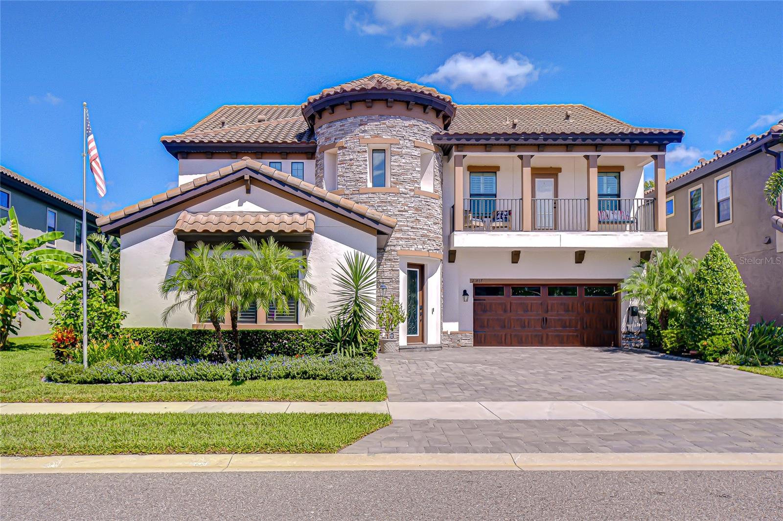 Discover luxury living at its finest in this extraordinary 5-bedroom, 4.5-bath, 3-car garage estate in the exclusive GATED community of Pristine Lake Preserve. Built in 2021 and offering 4,536 sq. ft. of elegantly designed living space, this home blends timeless style with modern convenience and enjoys a serene conservation setting with access to a 25-acre spring fed lake.
From the moment you arrive, the curb appeal captivates with a turret-style entry, stacked stone accents, paver driveway, wood-styled garage doors, architectural lighting, and an inviting second-level balcony. Step inside the dramatic two-story foyer with soaring ceilings, a statement chandelier, and a sweeping staircase with wrought-iron detail. Natural light pours through expansive windows, showcasing the open floor plan designed for both entertaining and everyday living. Crown molding and Plantation shutters throughout.
The gourmet kitchen is the heart of the home and an entertainer’s dream. Outfitted with Quartz countertops, glass backsplash, high-end stainless appliances, a gas cooktop, double wall ovens, walk-in pantry, and an oversized island, it flows seamlessly into the spacious living area and formal dining room. A private home office with French doors is ideal for work-from-home or quiet study.
This thoughtful floor plan features two primary suites, offering both comfort and versatility. The main suite is a retreat of elegance, featuring wood ceiling beams, crown molding, and an ensuite spa-inspired bathroom. The bath boasts a Granite topped double vanity with built-in towers, a frameless glass shower, tiled with bench seating, and dual closets. A second primary suite enhances flexibility making it ideal for multi-generational living or long-term guests.
The upper level unveils a loft enhanced by a well-appointed mini kitchen, perfect for everything from intimate family gatherings and festive movie nights to refined study or leisure. Two bedrooms share a stylish Jack-and-Jill bath, while a distinguished bedroom five boasts balcony access with panoramic views of the tranquil pond and pristine preserve—an exclusive sanctuary for relaxation.
The resort-style backyard is your private oasis. Slide open the quadruple glass doors to a screened lanai featuring a cozy outdoor fireplace, heated pool with sheer descent waterfall, sundeck with fountains, architectural lighting, and abundant space to lounge. The full outdoor kitchen, finished with stacked stone is equipped with a gas grill, beverage fridge, prep area, and bar—making alfresco dining a breeze. Beyond the lanai a brand-new 15x54 paver patio with firepit creates the ultimate setting for year-round entertaining. Professionally designed tropical landscaping ensures both beauty and privacy, with serene water and preserve views as the backdrop.
Pristine Lake Preserve offers residents exclusive access to private spring-fed Curve Lake, private boat ramp, dock, and beautifully maintained park. Low HOA fees and no CDD! Featuring extensive upgrades and a lifestyle that balances luxury and comfort, this home is truly one-of-a-kind. Don’t wait — schedule your private showing today and experience the dream of living in Pristine Lake Preserve!