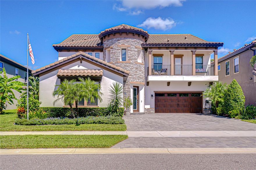 Discover luxury living at its finest in this extraordinary 5-bedroom, 4.5-bath, 3-car garage estate in the exclusive GATED community of Pristine Lake Preserve. Built in 2021 and offering 4,536 sq. ft. of elegantly designed living space, this home blends timeless style with modern convenience and enjoys a serene conservation setting with access to a 25-acre spring fed lake.
From the moment you arrive, the curb appeal captivates with a turret-style entry, stacked stone accents, paver driveway, wood-styled garage doors, architectural lighting, and an inviting second-level balcony. Step inside the dramatic two-story foyer with soaring ceilings, a statement chandelier, and a sweeping staircase with wrought-iron detail. Natural light pours through expansive windows, showcasing the open floor plan designed for both entertaining and everyday living. Crown molding and Plantation shutters throughout.
The gourmet kitchen is the heart of the home and an entertainer’s dream. Outfitted with Quartz countertops, glass backsplash, high-end stainless appliances, a gas cooktop, double wall ovens, walk-in pantry, and an oversized island, it flows seamlessly into the spacious living area and formal dining room. A private home office with French doors is ideal for work-from-home or quiet study.
This thoughtful floor plan features two primary suites, offering both comfort and versatility. The main suite is a retreat of elegance, featuring wood ceiling beams, crown molding, and an ensuite spa-inspired bathroom. The bath boasts a Granite topped double vanity with built-in towers, a frameless glass shower, tiled with bench seating, and dual closets. A second primary suite enhances flexibility making it ideal for multi-generational living or long-term guests.
The upper level unveils a loft enhanced by a well-appointed mini kitchen, perfect for everything from intimate family gatherings and festive movie nights to refined study or leisure. Two bedrooms share a stylish Jack-and-Jill bath, while a distinguished bedroom five boasts balcony access with panoramic views of the tranquil pond and pristine preserve—an exclusive sanctuary for relaxation.
The resort-style backyard is your private oasis. Slide open the quadruple glass doors to a screened lanai featuring a cozy outdoor fireplace, heated pool with sheer descent waterfall, sundeck with fountains, architectural lighting, and abundant space to lounge. The full outdoor kitchen, finished with stacked stone is equipped with a gas grill, beverage fridge, prep area, and bar—making alfresco dining a breeze. Beyond the lanai a brand-new 15x54 paver patio with firepit creates the ultimate setting for year-round entertaining. Professionally designed tropical landscaping ensures both beauty and privacy, with serene water and preserve views as the backdrop. 
Pristine Lake Preserve offers residents exclusive access to private spring-fed Curve Lake, private boat ramp, dock, and beautifully maintained park. Low HOA fees and no CDD! Featuring extensive upgrades and a lifestyle that balances luxury and comfort, this home is truly one-of-a-kind. Don’t wait — schedule your private showing today and experience the dream of living in Pristine Lake Preserve!