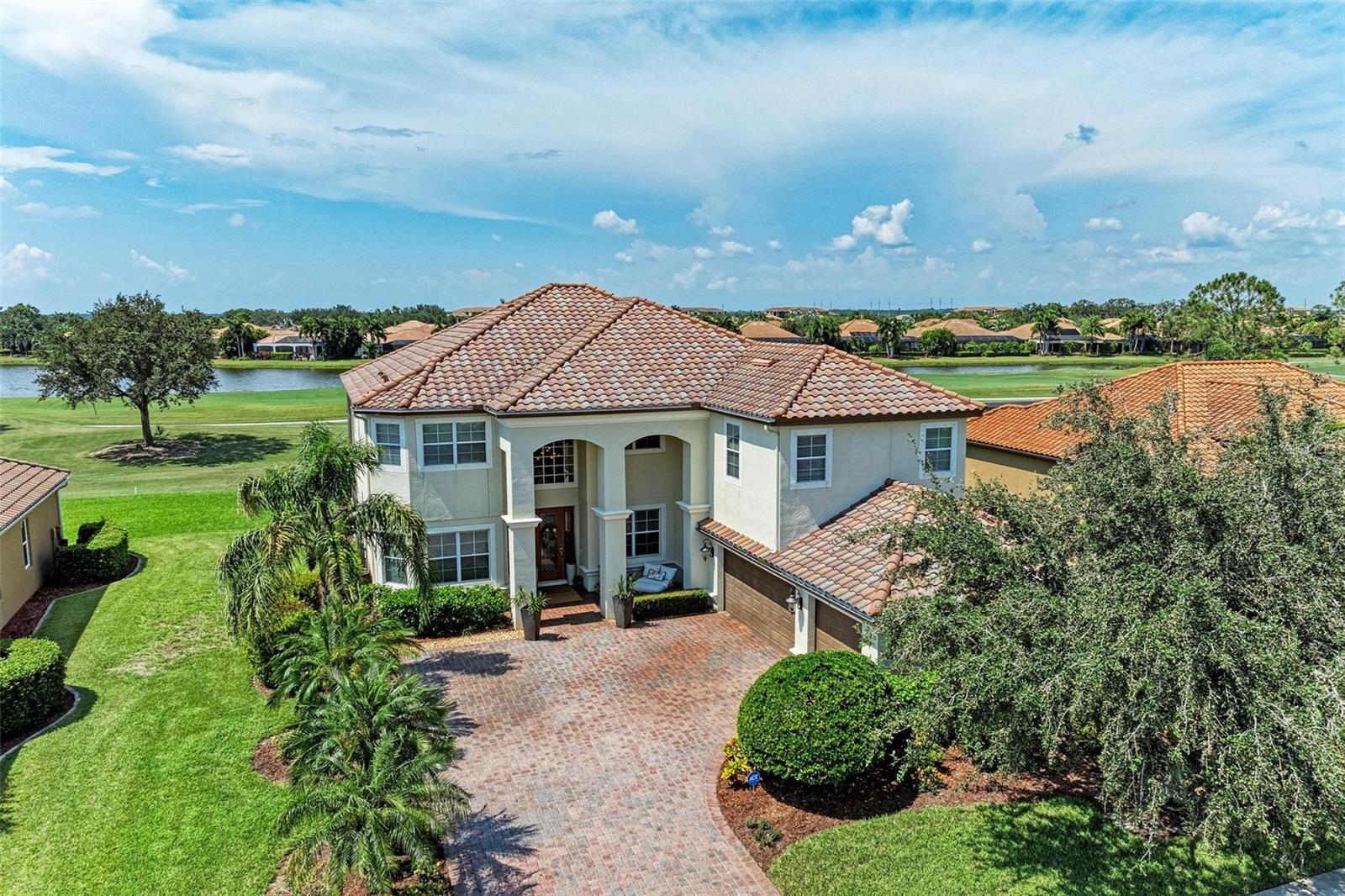 Welcome to The Estates at River Strand Golf & Country Club! This exquisite 5 bedroom, 4 bath home has been lovingly cared for and stylishly updated and includes a den, a loft, and spacious bonus room! The newly renovated (2023) gourmet kitchen has quartz countertops with pop up outlets and matching quartz backsplash, two tone cabinets, new high end stainless steel appliances with range hood, custom soft close cabinetry, a pantry, under counter LED lighting, and ledger stone touches that match the fireplace. The kitchen flows into the family room with a new electric 74 " Ledger Stone Fireplace with marble mantel and hearth, sliding doors to the lanai, and golf course views. The large dining room is off the kitchen and is perfect for entertaining. The private, brick paver lanai has a NEW screen cage, plenty of covered space, a bar/grill , a hot tub, heated pool, and a pool bath entrance. The grand split staircase has newly installed engineered hardwood floors that continue throughout the upstairs. The owner’s suite is luxuriously appointed with beautiful golf course and lake views, walk-in custom built closets , and a slider door to lanai patio. The ensuite has dual vanities, a garden tub, and a walk-in shower. The three additional bedrooms are perfect for family and guests, two of which have entrance to the covered second story lanai patio and expansive views. The upstairs also has a loft and a HUGE bonus room with a bathroom that could be used as an additional bedroom. The pics say it all about the thoughtful touches that went into this beautiful home! Additional upgrades include lighting, fan fixtures, kitchen hardware, as well exterior/interior paint, new pool pump, remote control hurricane see through drop down covers with remote control and Bond bridge for wi-fi app control, 2 NEW A/C units with programmable thermostats, a whole home water softner & Reverse Osmosis, Engineered Hardwood flooring has 100 yr warranty! This immaculate home has over $150k of upgrades! River Strand Golf & Country Club offers so many amenities for your lifestyle; Recently renovated 27 Hole Andrew Green designed golf course, aqua driving range, 9 Har Tru Tennis Courts, 8 Pickleball Courts, 2 Resort Style Pools, 6 additional pools, Clubhouse with restaurant, social events, Tiki Bar, 2 fitness centers, 24- hour security, and lawn maintenance! Conveniently located near I-75, Costco, UTC Mall, and our beautiful Gulf Beaches! Make this Dream Home yours!