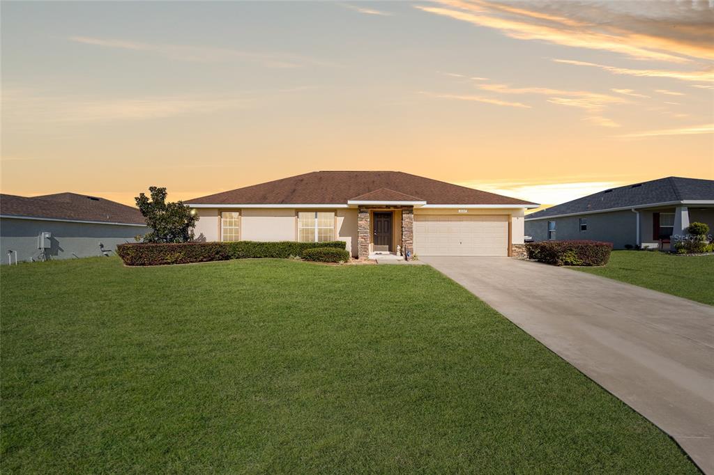 Welcome to this fantastic home in Summercrest! Why wait to build? Move in now and enjoy this home perfect for entertaining with an open floor plan, neutral color palette, and plenty of room to entertain. Spacious living area with low maintenance tile floors, high ceilings, and sliders to outdoors. Kitchen features recessed lighting, plenty of prep space, and a pantry for extra storage space. Enjoy your tea and coffee time on the screened lanai with beautiful sunrises and sunsets! This neighborhood offers an easy commute to Ocala, Belleview, and The Villages with miles of lighted roads throughout the neighborhood, great for walking, jogging or cycling.