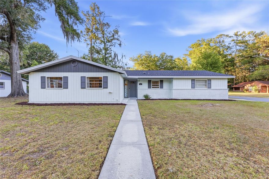 Situated on a spacious corner lot in the non-HOA Northwood neighborhood, this well-maintained 3 bedroom, 2 bath home offers a great blend of indoor comfort and outdoor space. The roof was replaced in 2022, and the home has just been repiped along with a brand new water heater, giving buyers added peace of mind. The home has been recently painted and features an open kitchen that overlooks the dining area, with laminate wood flooring running through the main living spaces. The large living room centers around a wood-burning fireplace, creating a comfortable and functional gathering space. The kitchen includes updated appliances and connects easily to both the dining and living areas. Both bathrooms have been remodeled, adding a clean, updated feel throughout. The oversized side-entry garage provides extra storage and flexibility. Out back, the yard is fully fenced with plenty of room to spread out, along with a storage shed and a screened porch that offers a great place to relax and enjoy the space year-round. Located approximately 5 miles to UF and Shands and convenient to shopping and dining, this home offers a strong combination of updates, layout, and location.