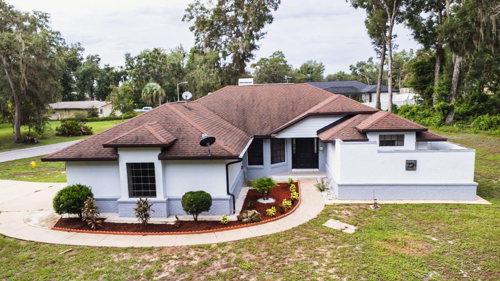RELEASE YOUR INNER PINTREST!! CORNER LOT PROPERTY!!! When you arrive at this 2034 sqft home you'll immediately realize it was once one of the premier homes in the neighborhood. With some imagination and creativity you could easily restore this great home to it's original grandeur. Situated in the quiet, stable Westlake community on a roomy .41 ACRE corner lot. The property is complete renew and all the appliances are new.
Floor plan features a family room, living room, and 2 1/2 BATHS plus a large wraparound screen enclosed lanai with a peaceful, wooded view. The family room is centered around a brick hearth wood burning fireplace and has access to lanai via pocket sliding glass doors that retract completely behind the wall. Lanai access is also available in the living room and master bedroom. Master suite includes a bathroom with a walk in shower, dual sink and a big closet . Large cook's kitchen is open to the family room allowing interaction with guests and family while entertaining or cooking. Easy 45 minute commute to Tampa or Orlando attractions. Contact your agent and check out this affordable, spacious home in person