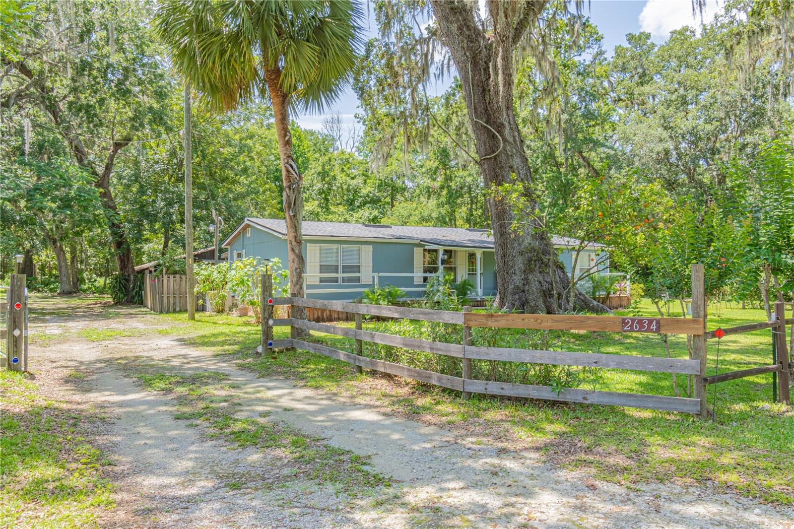Your own slice of paradise! Tucked away on the outskirts of town sits a cute, quiet, and quaint Manufactured Home on 10 peaceful acres. Meticulously maintained, this 1352 SqFt home features 3 Bedrooms, 2 Bathrooms, 2 Living Areas, and even more square footage attached in the form of a Screened Porch and Bonus Room that could be used for Crafts, as an Office, or just Extra Storage. Updates include New Roof (2024) with transferable warranty, Whole House Re-plumbed (2022), New Duct-work, New Flooring in the bedrooms & bathrooms, and Fresh Paint throughout. Moving outside you will find the property mostly wooded and lined with trails. Spend your afternoons watching the wildlife, scouting the land for hunting season, entertaining friends & family on the back patio & outdoor kitchen, or picking your fresh oranges & tangerines for a light snack. Feel free to get some plinking in, or fire up the table-saw and craft away in your workshop/garage. Enjoy the property how you want to, without the restrictions of others nearby. This truly is, your own slice of paradise. The Town of Lake Panasoffkee offers an A+ Elementary School, Amazing Local Restaurants, and a true spring fed lake that is one of Florida's best hot spots for large mouth bass, bluegill, sunfish, and catfish. The property nearly backs up to the Jumper Creek Wildlife Management Area, and you're less than a mile to Marsh bend outlet park which grants access to both the Lake and the Withlacoochee River. Enjoy rural living while being minutes from I-75, allowing easy commute to Orlando, Gainesville, Tampa, and the Villages. This property is something you truly need to see for yourself, schedule an appointment today! (Equal Opportunity Housing)