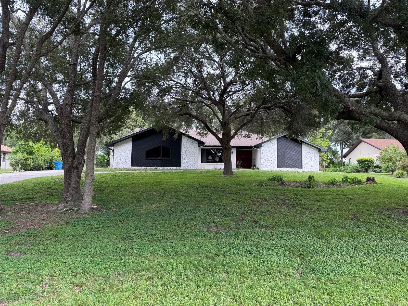BRUISED CREDIT OK! OWNER FINANCING AVAILABLE AS IS .NEW ROOF 2019 Located in River Country Estates with a low $125 annual HOA fee with access to community park. This home sits high with a side entry garage long driveway, mature landscaping and half acre lot. Enter though the front double doors into the formal living and dining area with vaulted ceilings, sliders to the lanai and wood laminate flooring. To the right is the master bedroom suite with a large walk in closet, private bathroom with skylight and walk in shower. Past the formal living areas is the open kitchen with tons of cabinets and storage. The kitchen has breakfast island seating for 8 and is open to the large eat-in kitchen area and family room with stone front fireplace. Just beyond the family room are the 2 large guest bedrooms with guest bathroom. The HUGE under roof lanai with outdoor kitchen TO BE area looks onto the private backyard. Ready to move in and make a house your home? If you’ve got a down payment but are still working on your credit score, don’t let that hold you back—this could be the opportunity you’ve been waiting for. Let’s talk Rent to Own options and help you take that next step toward homeownership.