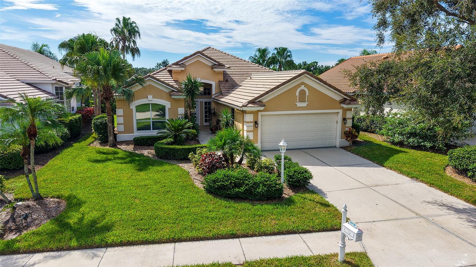 Welcome to this beautifully maintained and tastefully updated 3-bedroom, 2.5-bath home with an office, located in the award-winning University Park Country Club. From the moment you arrive, the tropical landscaping, pavered walkway, and sleek glass-paneled double doors with transom window set the stage for the inviting atmosphere inside.
The open-concept living and dining room is filled with natural light and features soaring ceilings, modern lighting, designer ceiling fans, and diagonal tile flooring that flows seamlessly throughout much of the home. The spacious eat-in kitchen is a chef’s delight, offering a center island with gas cooktop, granite countertops, tiled backsplash, built-in oven and microwave, pantry closet, recessed lighting, and abundant cabinetry. A breakfast bar, charming window seat, and desk area add function and character. The adjacent laundry room includes a washer and dryer, sink, storage closet and access to the two-car garage.
The living area is anchored by an electric fireplace framed with built-in nooks and elegant crown molding. Just off the living space, a private office/study offers flexibility as a den or formal dining room. Expansive fully-retractable sliding doors extend the living space outdoors to the lanai.
The primary suite is a retreat with hardwood floors, tray ceiling, Bermuda shutters, retractable sliders to the lanai, and a stunningly renovated ensuite bath. Here you’ll find quartz countertops with dual sinks and a makeup vanity, a free-standing soaking tub, zero-entry walk-in shower, double frosted glass doors to a large closet, and sleek designer finishes. Two guest bedrooms with hardwood floors, shutters, and ceiling fans share an updated bath with granite countertops and a tub/shower combination with glass enclosure.
Step outside to the expansive lanai, designed for both relaxation and entertaining. Featuring leather marble pavers, a grill area, sparkling pool, and infinity screened enclosure with serene lake views, it also includes a convenient pool half-bath.
Peace of mind comes with a NEW ROOF (2023), HVAC (2018), and NEW POOL EQUIPMENT, pump, and heater. As part of the maintenance-free Virginia Water neighborhood, residents also enjoy a community pool and a carefree lifestyle.
This home combines elegance, functionality, and resort-style living—all within the renowned University Park Country Club community.
University Park Country Club is consistently ranked one of the top courses in Florida featuring 27 holes of championship golf; tennis and pickleball; fitness center, croquet – as well as an array of social and group activities. Just a short drive outside this peaceful enclave is downtown Sarasota, with shopping, arts & theatres, museums, dining and entertainment, top-ranked healthcare, beaches and SRQ International Airport.