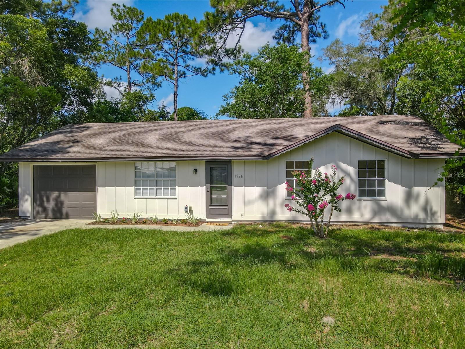 Welcome to your dream home in beautiful DeLand, Florida—where modern elegance meets peaceful country living. This completely remodeled 3 bedroom 1.5 bath residence offers the perfect blend of stylish design and everyday comfort, situated on a spacious, fully fenced lot. Step inside to discover an open and airy floor plan enhanced by luxury vinyl flooring throughout, providing both durability and a contemporary aesthetic. The gourmet kitchen is a true showstopper, featuring gleaming quartz countertops, custom cabinetry, and sleek finishes ideal for both entertaining and daily living. The bathrooms have been thoughtfully redesigned with high-end fixtures with a modern flair. A brand-new HVAC system ensures year-round comfort and efficiency. Outdoors, enjoy the serenity of your expansive backyard, perfect for gatherings, gardening, or simply enjoying the quiet, country-like setting. Located just moments from Cypress Lake Park, you'll have convenient access to a scenic playground, boat launch, and waterfront relaxation, making this location ideal for outdoor enthusiasts and families alike. Don’t miss this opportunity to own a turn-key, modern retreat in a charming DeLand neighborhood. Schedule your private showing today!