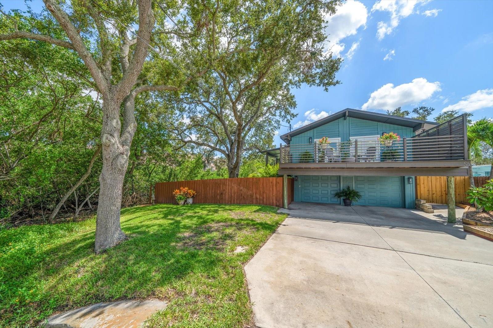 Unique Opportunity for a Tastefully Remodeled Designer-Owned Hidden Gem Tucked Away at the end of a Quiet Street in Clearwater. An Expansive Deck Surrounds the Home & not only offers Gorgeous Views, but is an Extension of the Living Area & serves as a Serene Connection with Nature. The massive garage area can accommodate 4 vehicles or serve as a space for Artists, Mechanics, Wood Shop or other Hobbies. Brazilian Cherry Hardwood Floors. Brand New Roof 2025. The Master Bedroom Opens to the Front Deck, features a Large Walk-In Closet & Stunning Bathroom with Granite Counter, Vessel Sink & Glass Enclosed Shower. This Convenient central County location is just minutes to Tampa, St Pete, Shopping, Golf Courses Dining & World Class Beaches. Those Particular Buyers who are bored with the abundance of cookie cutter homes on the market will truly appreciate this Meticulously Maintained Custom Stilt Home.