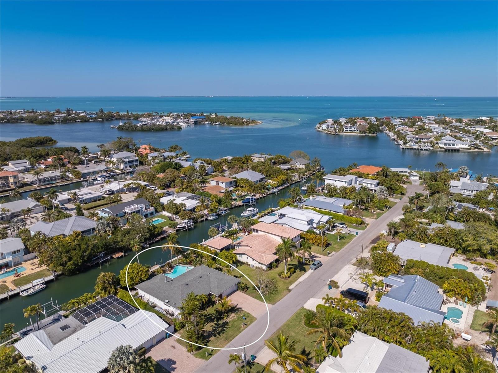 Stunning 3 bed, 3 bath home on deep sailboat water with 103' waterfront in Holmes Beach, FL. Impeccably maintained, featuring an open floor plan, new seawall, dock, mature landscaping, and a beautiful pool/spa. Enjoy the convenience of walking to Anna Maria's white sand beaches, restaurants, and shops. Ideal for those seeking a waterfront haven with modern amenities and proximity to local attractions.