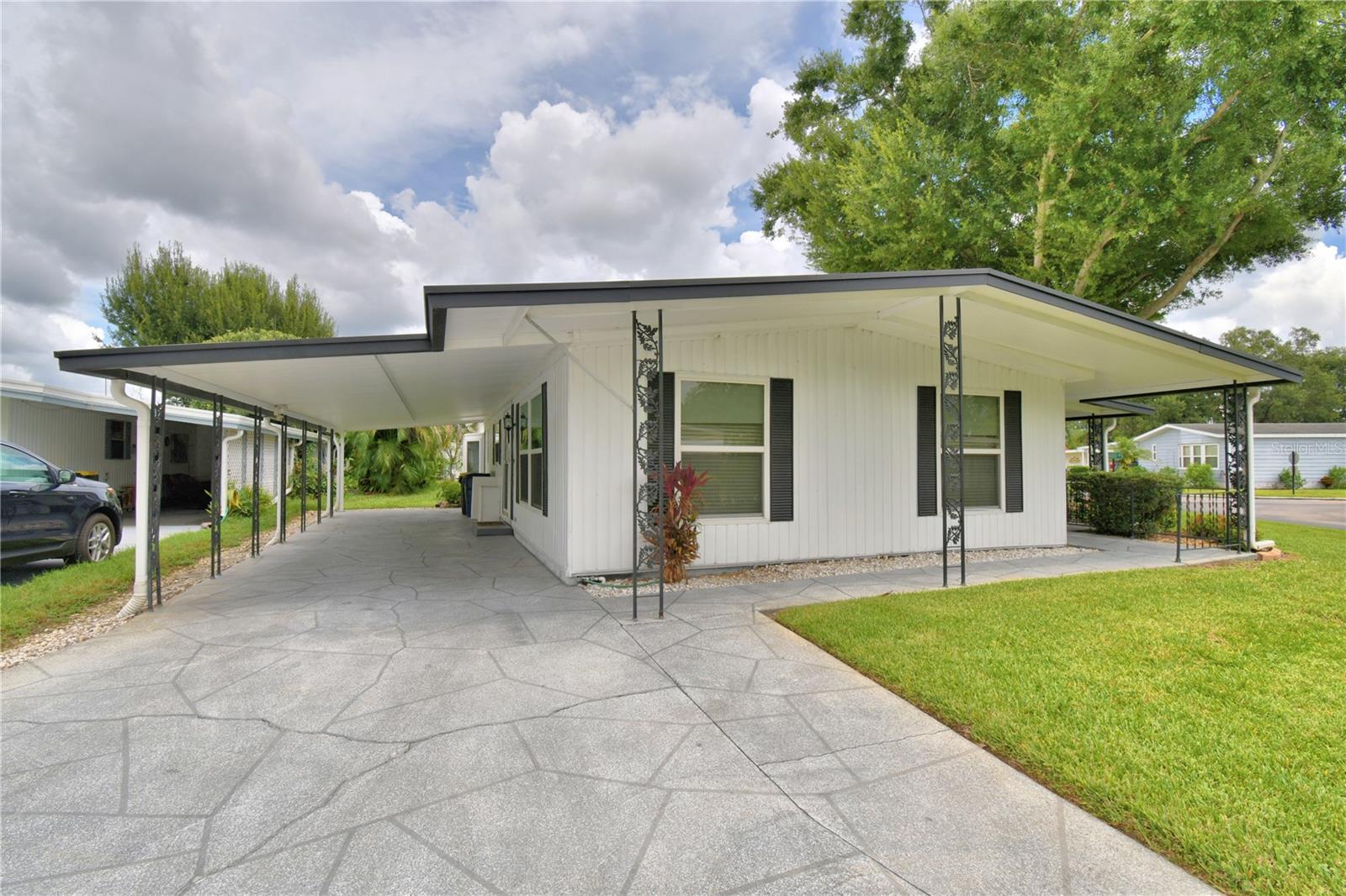 Welcome to Ariana Shores, one of Auburndale’s most sought-after 55+ communities!
This charming 2-bedroom, 2-bath home sits on a spacious corner lot and has been thoughtfully maintained with peace-of-mind updates, including a professionally sealed roof (2025), a new moisture barrier (2025), and updated tie-downs.
Inside, you’ll find a large living room, a breakfast room, a separate dining room, and a bright, open layout perfect for entertaining. Enjoy the outdoors year-round on the large, screened porch, with an adjacent storage room featuring a garage door—ideal for easy golf cart storage. Residents of Ariana Shores enjoy a vibrant, active lifestyle with amenities such as a heated pool, shuffleboard courts, a boat ramp for lake access, and more. This is a Co-Op Community, and the $30,000 Co-Op Share is included in the list price—making this home an excellent value. Move-in ready and waiting for you—call today to schedule your private showing and make this beautiful home yours!