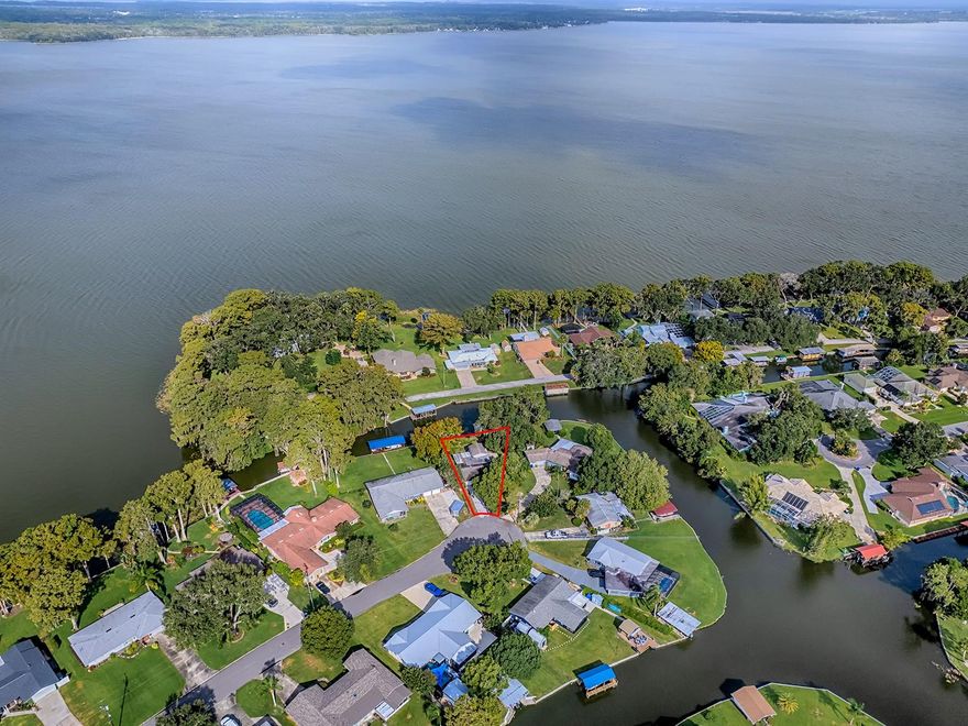 One or more photo(s) has been virtually staged. Harris Chain of Lakes is calling your name! Come enjoy this solidly built concrete block home nestled on a peaceful, dead end Cul-de-Sac with stunning views of canal frontage and views of Lake Eustis.  This home is the 3rd property on the canal from the entrance to the Chain of Lakes! The 2 bed, 2 bath, 1 car garage home features ceramic tile flooring throughout with carpet in the bedrooms.  Enter via the decorative leaded glass front door into the living room which looks straight through the dining area, office/den, to the Sun Tower, to awesome canal front and boat house views.  Kitchen boasts:  skylight; built in wall oven & microwave; cooktop range, dishwasher, tiled backsplash; Maytag refrigerator w/ French Doors, quick middle drawer, bottom freezer, ice & water dispenser on door; passthrough window to office/den.  Utility room off of kitchen is equipped w/laundry sink, washer/dryer hookups, cabinet storage and built in shelves.  Exits from the utility room open to the garage on one side and the huge lanai on the other.  Lanai just received brand new epoxy texture flooring (garage & driveway also) to add comfort to beautiful canal views looking out the perimeter of screened, acrylic, sliding windows.  Outside of this room is even a hook up for a hot tub! Office/Den has a skylight and water view while you work.  Now, for the Gem, The Sun Tower! A permitted addition in 2004 which adds grace and serenity to the home.  15' vaulted wood ceiling, two large ceiling fans & custom lighting, windows offering beyond natural light, foliage sites, water and boathouse scenic to the senses.  Triple glass slider doors adorn the canal side of this room, opening onto a fenced wooden deck, covered by a retractable Somfy Awning.  Glass doors also open into the main home.  There is an irrigation  well from the canal which can also be used to wash the boat & clean fish.  More items of information:  HVAC 1 year new; Tavares is the Lake County Seat as the Government hub is close by; many restaurants provide waterfront dining accessible by boat; no HOA; Tavares is also known as the "Sea Plane City" for lake landings & take offs; Charming downtown shopping & bistros.  Be sure to watch the attached video.  Enlarge the still photos by clicking in the center of the photo on this page to see details of the property, lake and captions. Come See, Come Love, Come BUY!