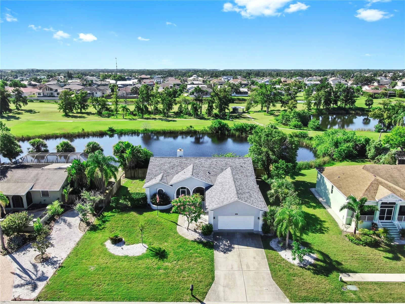 Your House Hunting stars have aligned! Situated on a scenic gorgeous lot measuring 101x125ft this elevated one story home offers 4 FULL bedrooms and is free from deed restrictions with NO HOA! Recent 2024 upgrades include trimmed out DUAL Fireplaces with one wood burning in the main living room and electric in the primary room emitting stylish ambiance and cozy nights. Wall to wall expansive new waterproof 60x9in luxury plank floors in "finished pine" influence the earthy tones from outside into this open living floor plan. 3 bedrooms line one side of the home, while the Primary en-suite sits opposite for added privacy. In the center of this home is a vast family room opening up to the sparkling white kitchen with plenty of counter space for food prep! A cozy breakfast room with large windows is a coffee lover's dream overlooking quiet serene nature with multiple ponds. Plus a designated well lit dining area offers entertaining space for larger gatherings, or it could also easily be enclosed to serve as a den or office space! The HIGHLIGHT of the home remodel lies within the STUNNING primary and guest baths. Adorned by beautiful tilework, you will melt your day away in the stand alone tub within the primary shower. New vanities add a coastal pop of color and add a unique charm. His and Her closets in the primary bedroom and sliders to the lanai offer ease and comfortable living space. A screened front porch allows for covered and secured deliveries or watching the sunset on this low traffic street. Your outdoor exercise experience will never be the same! Enjoy walks down to the open water of Tampa Bay in the cul de sac...OR within steps reach an access path to stroll the former golf course paved walkways full of feathered friends and critters. The expansive screened in rear lanai offers you bug free enjoyment in your very own hot tub, complete with a grill and firepit. Backyard is fenced so bring your pups or grow a garden! Irrigation is provided by the pond and not on your water bill. NEW ROOF + Re-piped in 2020 + AC and Electric updated in recent years means reasonable insurance rates and savings. This home was not affected by any of the 2024 storms. Freshly painted inside and out with epoxy on the garage floor makes this property look and feel brand new. High ceilings with smart fans, and a huge laundry room with wide closets plus multiple linen closets offer ease and ample storage needed for day to day living. The Southshore area now offers state of the art medical facilities, fantastic waterfront dining with dolphins and sunsets, boutique shopping, coffee shops, multiple recreation centers, waterfront Nature Park, Manatee viewing center, the Freedom Boat Club, and the A rated school Apollo Beach Elementary! Accomplish all of your to do list without accessing major roadways! Absorb all the coastal experiences of Tampa Bay and then retreat home to one of the most sought after areas in town. Being move in ready, make the call now to easily come preview your new address in the 33572!
