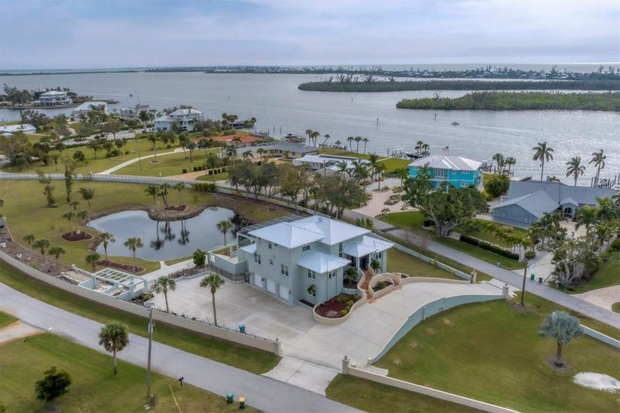 Significant renovation work has just been completed and new photos are now on MLS.  Incredibly rare walled compound in the historic Vanderbilt developed neighborhood of Cape Haze. Beautiful Mediterranean style home is across the street from the Intracoastal Waterway with sensational partial views and a brand new standing seam metal roof. The spectacular property grounds include about 1.76 acres that could be subdivided for a second home to be built or split off.  There's an expansive circular driveway, oversized three-bay garage, a private manicured lagoon with fountains, a gazebo/picnic area, 2,000 square foot screened lanai with an elevated pool and eight person spa that affords views of the water, all surrounded by 1,500 feet of privacy wall. The grand interior features about 3,500 sq.ft., three bedrooms and bathrooms, private office/den, 22 foot ceilings, and a completely renovated kitchen with custom cabinetry. Some drywall work is still needed in the garage ground level.  Its a great situation for someone wanting to have a like-new home with their own custom design style and not have to wait more than two years for a new construction. The elegant neighborhood showcases tree-lined streets with towering banyans and large-acreage properties. A short walk to the Association kayak launch or quick boat trip to the 400 ft of private beach that's next to the Don Pedro State Park. Enjoy the ultimate coastal lifestyle being just minutes from Boca Grande, miles of pristine sandy beaches, three full service marinas, essential shopping, plentiful dining options, dozens of golf courses, and world-class fishing and boating.