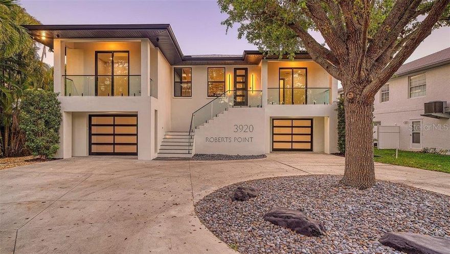 One or more photo(s) has been virtually staged. CERTAIN CRYPTOCURRENCIES ACCEPTED. An exquisite waterfront retreat in SIESTA KEY, SARASOTA, FL – a sanctuary of COASTAL LUXURY. Enter the fully REMODELED CONTEMPORARY residence with CUSTOM WOOD CABINETRY, DELUXE APPLIANCES, and STONE COUNTERTOPS. The great room with 11-FOOT CEILINGS and SLIDING DOORS flows to a 50-FOOT PORCH overlooking the water. This home boasts ESPRESSO CABINETRY, POLISHED NICKEL DETAILS, and an 8-FOOT CUSTOM FRONT ENTRY DOOR. The open-concept living area features IMPACT SLIDING DOORS and WINDOWS, creating seamless indoor-outdoor living. Premium finishes include LUXURY LVP FLOORING, a BUILT-IN STONE DINING TABLE, and a high-end THERMADOR & BOSCH Appliances. Entertain in the sophisticated bar area with the CUSTOM WALNUT shelving WINE COOLER, 2 U-line drink fridges, and a ICE MAKER. The PRIMARY SUITE is a private oasis with HIS AND HERS WALK-IN CLOSETS and an opulent bath with DUAL RAIN SHOWERHEADS, a STEAM SHOWER, a GLASS-WALLED SOAKING TUB, and STONE SURFACES. Three additional bedroom includes an EN-SUITE BATH with premium stone finishes. This waterfront sanctuary is loaded with high-end features: a SECURITY CAMERA SYSTEM, LED LIGHTING, and IMMERSIVE SOUND SYSTEM. The versatile LOWER LEVEL includes over 2500 SQ FT of garage space – ideal for CAR COLLECTORS or CRAFTSMEN. Located on ROBERTS POINT ROAD, great views of BAYOU NETTIE, a haven for BOATERS that offers QUICK ACCESS to SARASOTA BAY and a short two block walk to the sands of SHELL BEACH.